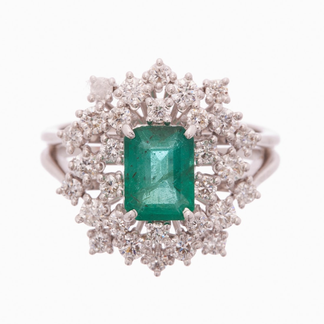 Emerald Ring with Diamond Setting: Emerald ring with diamond setting 750/- white gold, stamped. Total weight: 9.13 g. Centrally set emerald in emerald cut of 1.39 ct. Various brilliants totaling approx. 1.05 ct (w-tcr/vsi-si). Ring siz
