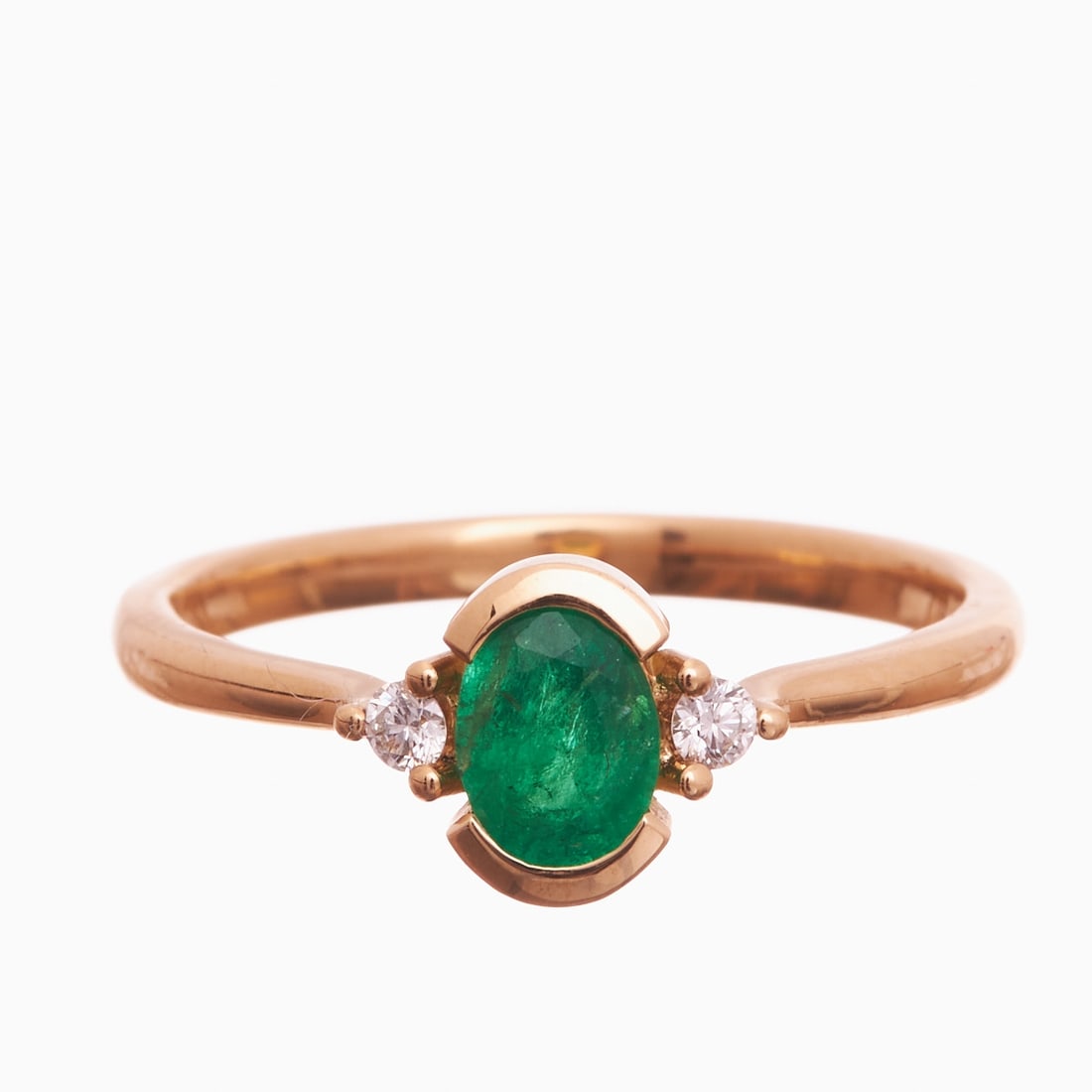Classic Emerald and Brilliant-cut Diamond Ring: Classic Emerald and Brilliant-cut Diamond Ring 750/- yellow gold, stamped. Weight 2.9 g. Centrally set oval-cut emerald of approx. 0.48 ct, flanked by two brilliant-cut diamonds totaling approx. 0.07