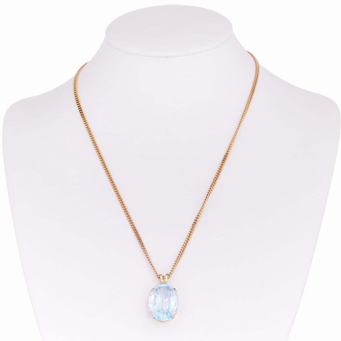 Blue Topaz Pendant with Chain: Blue Topaz Pendant with Chain 585/- yellow gold, stamped. Total weight: 12.2 g. Chain weight: 6 g. 1 oval-cut blue topaz of approx. 14 ct (17.8 x 14 x 8.4 mm). Chain L. 40 cm. Pendant L. 2.2 cm and