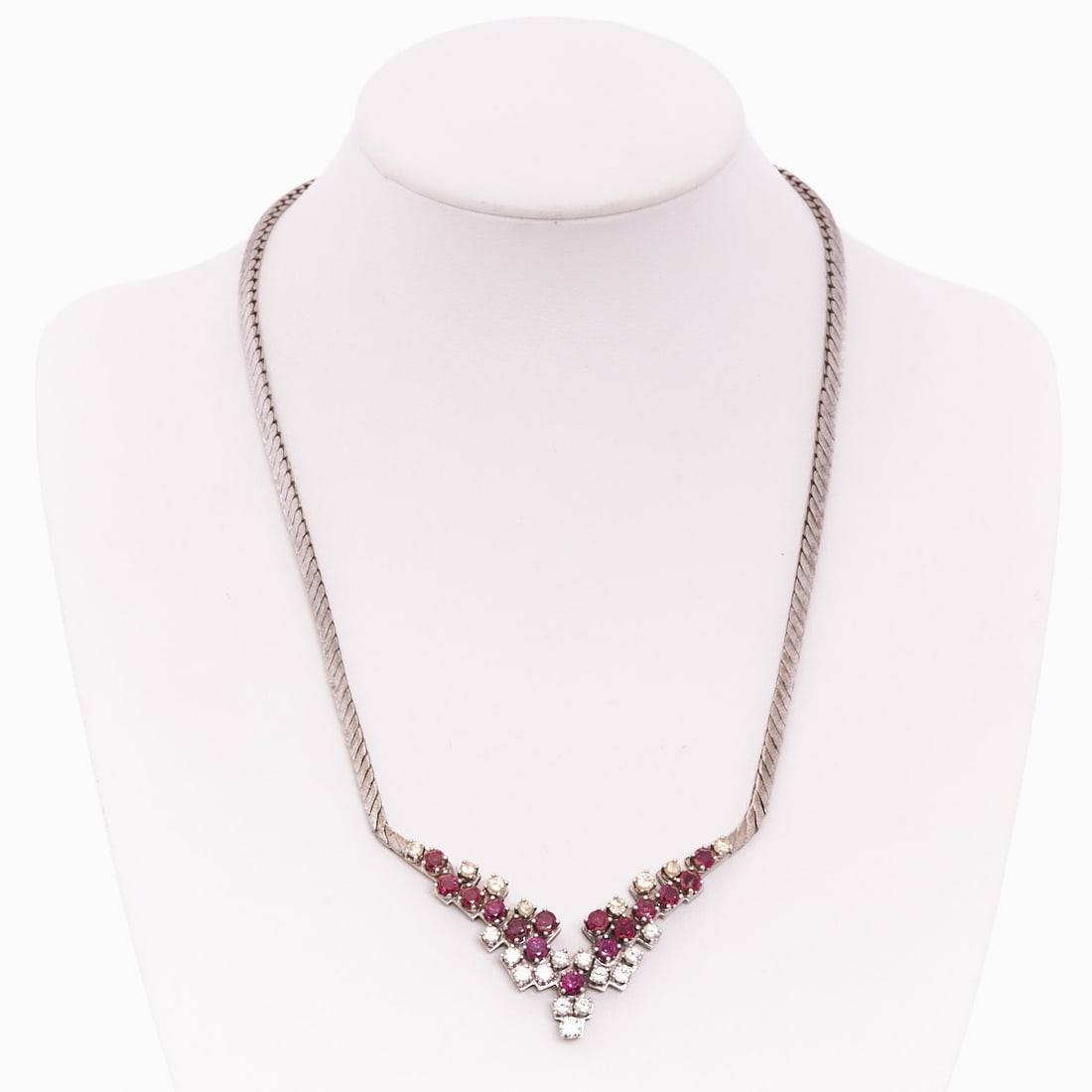 Ruby and Diamond Necklace: Ruby and Diamond Necklace Mid-Century, 1970s. 750/- white gold, stamped. Total weight: 43.7 g. Maker's mark "BE". Approx. 21 brilliants totaling approx. 1 ct (w/vsi-si). 15 rubies totaling