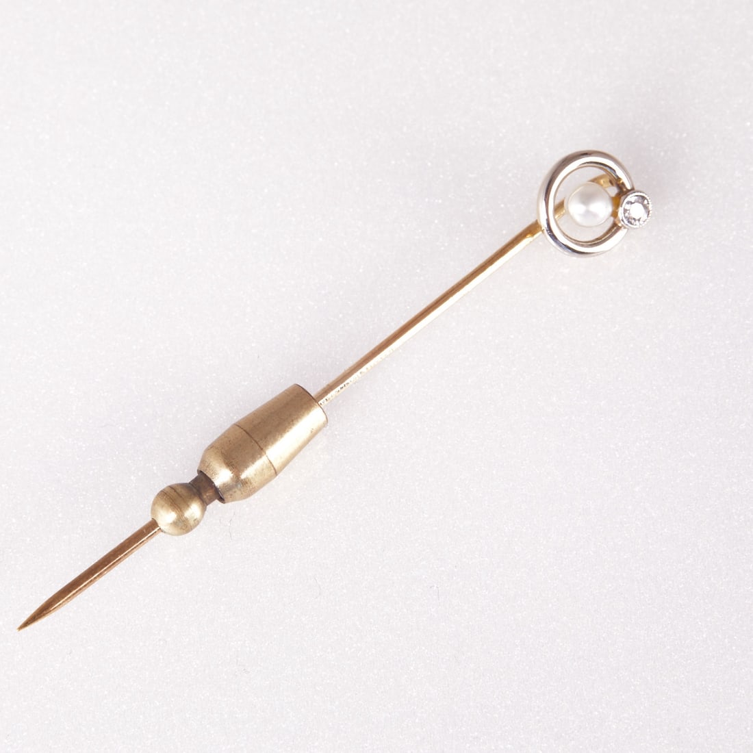 Tie Pin with Pearl and Brilliant-cut Diamond: Tie pin with pearl and brilliant-cut diamond 585/- yellow gold and white gold, hallmarked. Weight: 1.5 g (without stopper). 1 old-cut diamond approx. 0.05 ct. Pearl. L. 6 cm. W. 0.84 cm. Safety slide