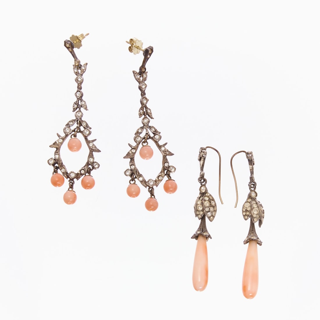 Two Pairs of Earrings with Coral-colored Stones: Two Pairs of Earrings with Coral-colored Stones Circa 1930. Metal, silver-colored. One pair of stoppers made of 585/- yellow gold, stamped. Coral-colored stones. Rhinestones. Weight: 18 g. Dimensions:
