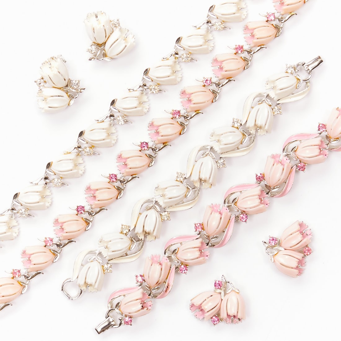 LISNER - Two Vintage Jewelry Sets with Tulip Motif (6 Pieces): LISNER - Two vintage jewelry sets with tulip motif (6 pieces) 2 necklaces, 2 bracelets and 2 pairs of ear clips. Lisner, New York, circa 1950. Metal, silver-colored with white/pink thermoset plastic a