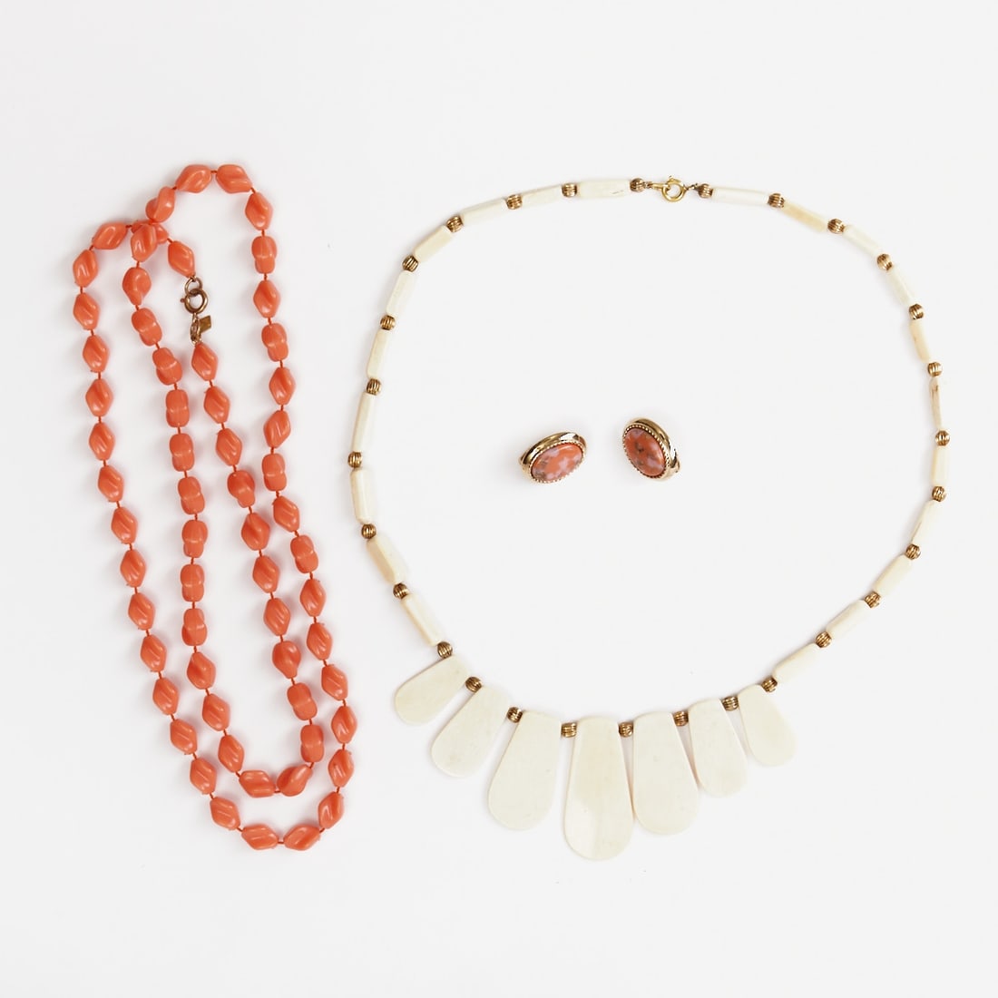 Sarah Coventry - Two Vintage Pearl Necklaces and a Pair of Ear Clips (3 Pieces): Sarah Coventry - Two vintage pearl necklaces and a pair of ear clips (3 pieces) Sarah Coventry Co., USA, circa 1960. Metal, gold-colored. Faux coral pearls. Ivory-colored pearls. Gold-colored pearls. 