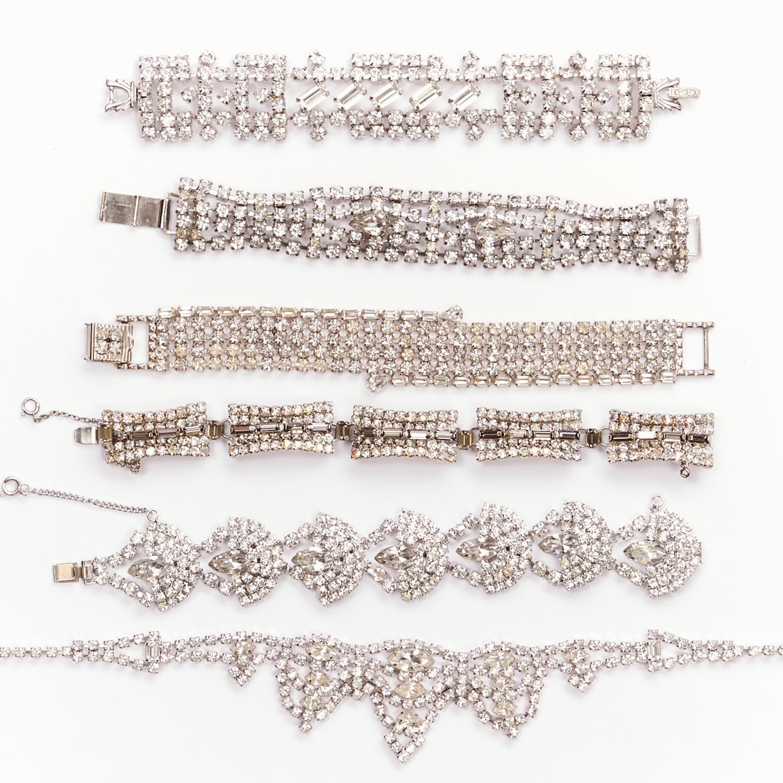 A Necklace and Five Bracelets with Crystal Rhinestones: A Necklace and Five Bracelets with Crystal Rhinestones 1 bracelet by Hobé. USA, circa 1940 - 1960. Metal with clear crystal rhinestones. Necklace length: 39 cm. Width: 3.8 cm. Bracelets: length