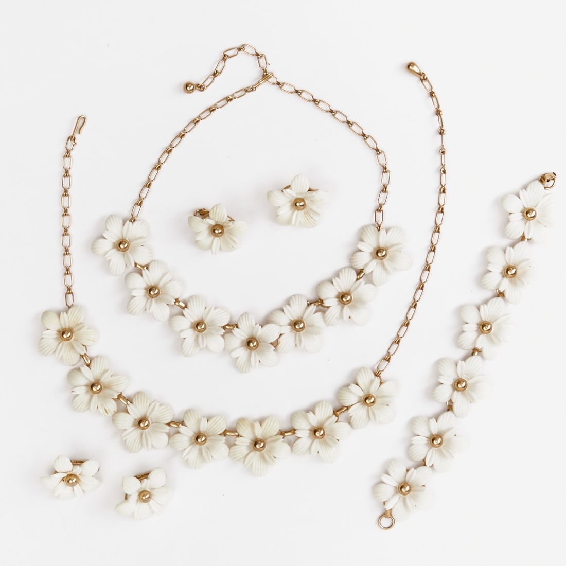 SARAH COVENTRY - Vintage Floral Jewelry Set (5 pieces): SARAH COVENTRY - Vintage Floral Jewelry Set (5 pieces) 2 necklaces, 1 bracelet and 2 pairs of clip-on earrings. Sarah Coventry Co., USA; circa 1964. Metal, gold-colored. Gold-colored pearls, Lucite. W