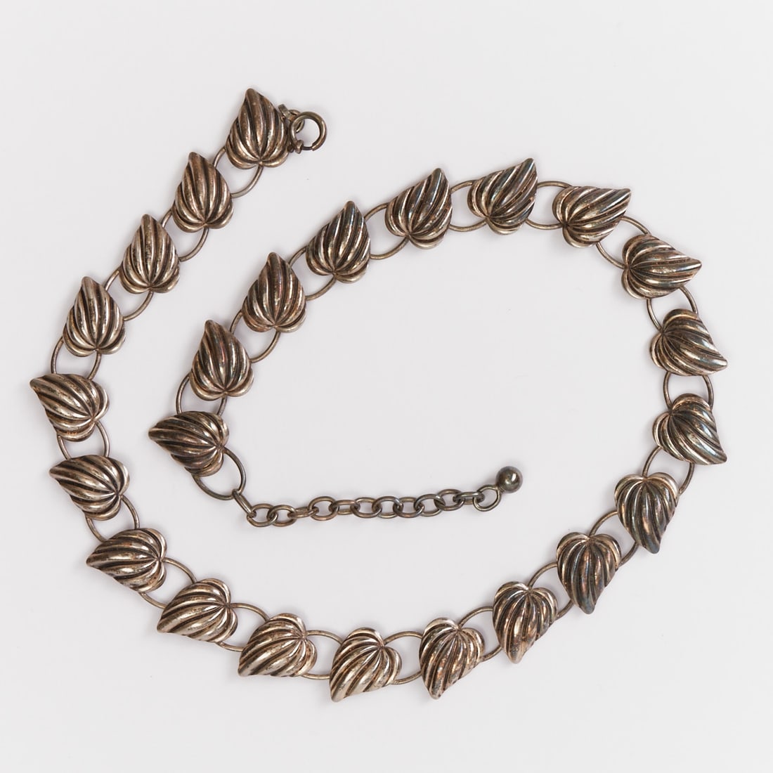 835/- Silver Necklace with Foliage Motif: 835/- Silver Necklace with Foliage Motif Probably circa 1950. 835/- silver, stamped: 835. Hallmarked. Weight: 24.6 g. L. 44 cm. W. 1.6 cm. Signs of wear.