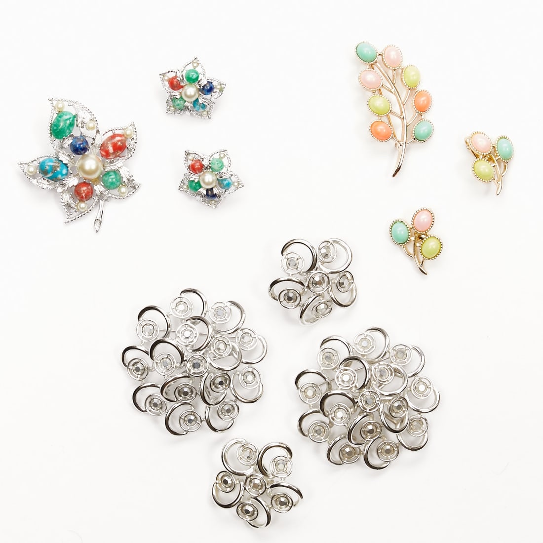SARAH COVENTRY - Three Vintage Brooch and Ear Clip Jewelry Sets (7 pieces): SARAH COVENTRY - Three Vintage Brooch and Ear Clip Jewelry Sets (7 pieces) 4 brooches and 3 pairs of ear clips. Sarah Coventry company, USA; circa 1964. Metal, silver-colored / gold-colored. Rhineston