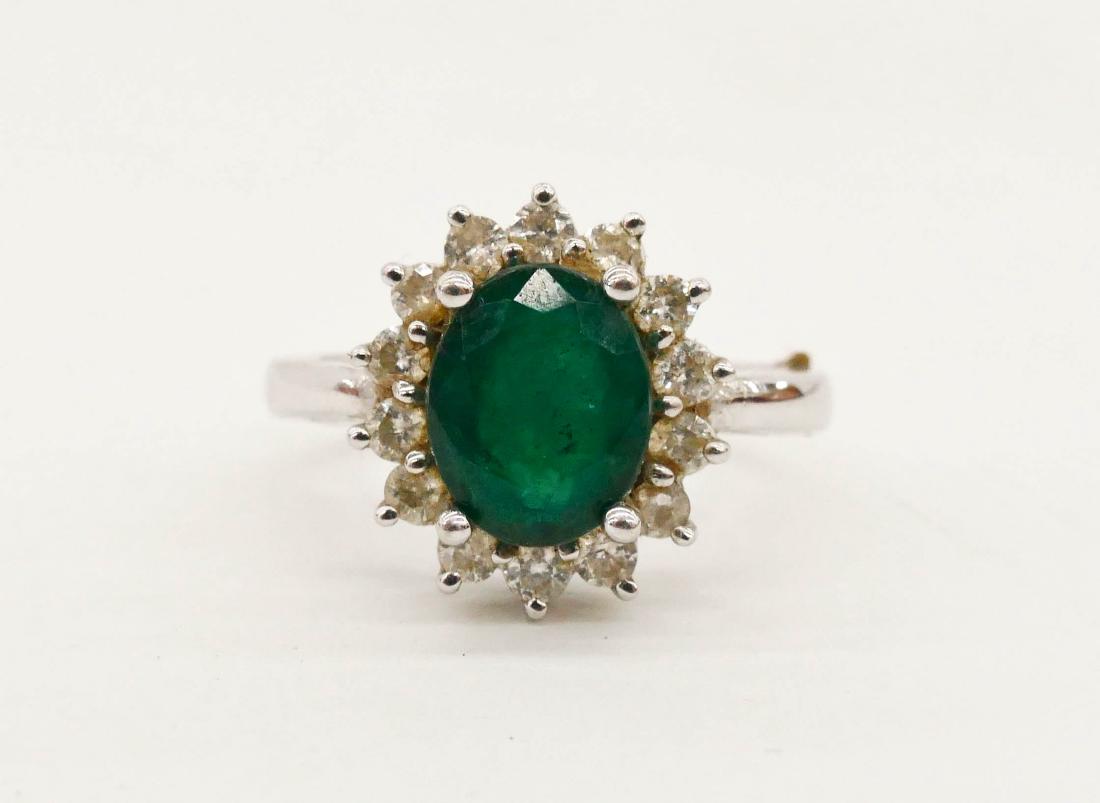 Lady's Emerald & Diamond White Gold Ring Size 7.5. One: Lady's Emerald & Diamond White Gold Ring Size 7.5. One semi-translucent oval mixed cut dark bluish-green emerald beryl measures 9.98x7.97x4.61mm. Surrounded by fourteen round brilliant cut diamonds of