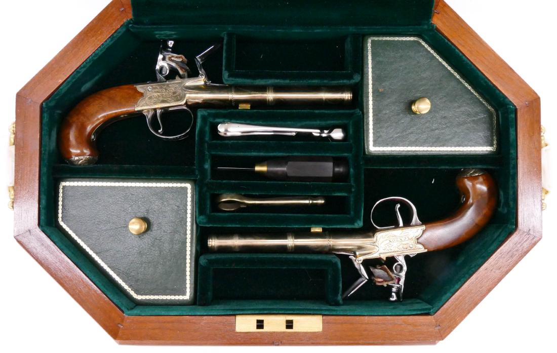 Thomas Jefferson Dueling Pistols Commemorative Set in: Thomas Jefferson Dueling Pistols Commemorative Set in Presentation Box 3.5''x17''x11''. A pair of brass decorated flintlock pistols serial number 192A & 192B. They come in fitted cherry box with tools