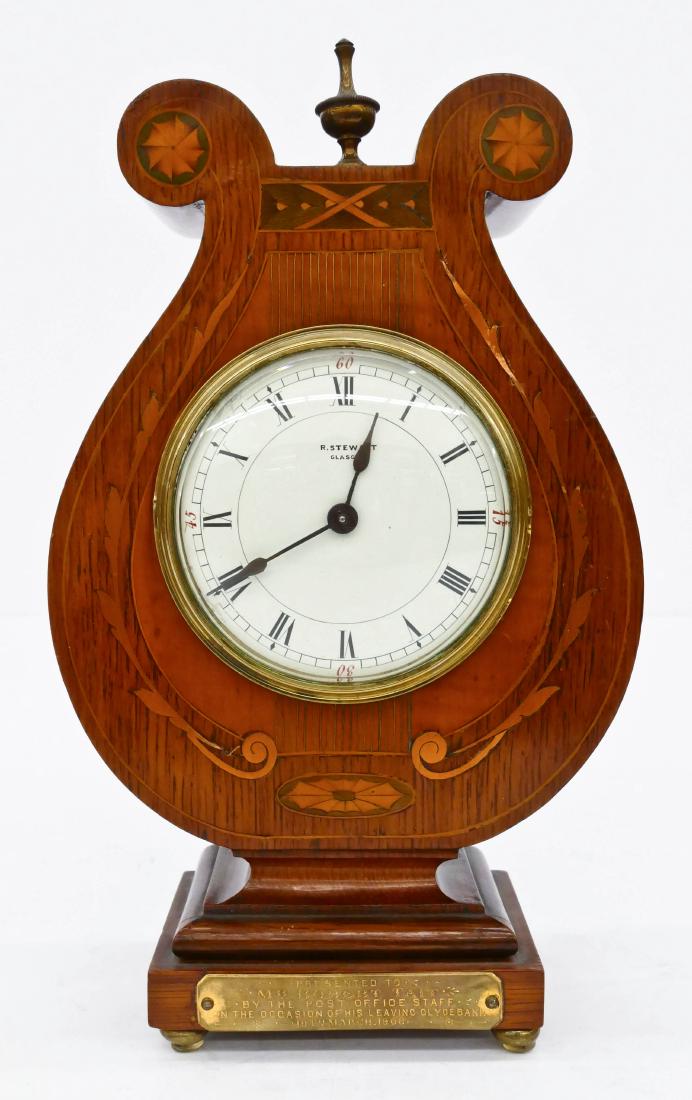 Scottish Inlaid Lyre Table Clock by R. Stewart, Glasgow: Scottish Inlaid Lyre Table Clock by R. Stewart, Glasgow 10.5''x6.5''. Satin wood and copper inlaid oak case with roman numeral dial. Presentation placard reads, ''Presented to Mr. Robert Tait by the P