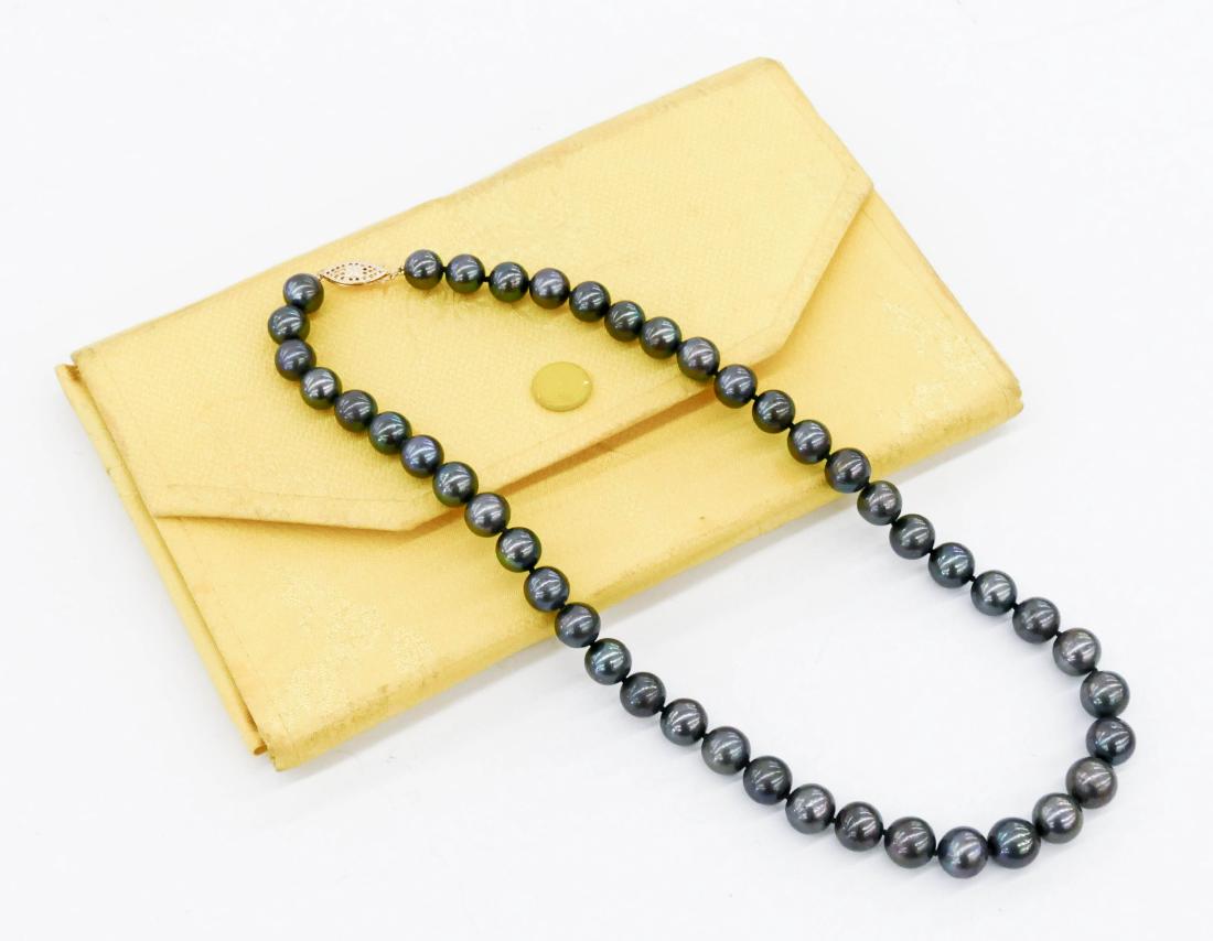 Strand of Gray Tahitian Large Pearls 18''. Includes: Strand of Gray Tahitian Large Pearls 18''. Includes forty four cultured gray tahitian pearls of 9-10.5mm each. It has a 14k gold filigree clasp. Current appraisal included by North American Gemologica