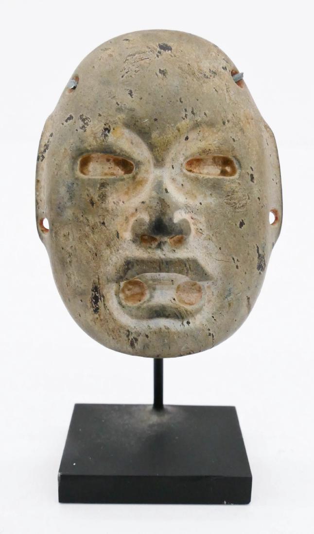 Olmec Stone Maskette on Stand 3.5''x2''. A finely: Olmec Stone Maskette on Stand 3.5''x2''. A finely carved Were Jaguar shaman miniature mask 2.5''x2''. Red museum numbering on verso. Overall excellent condition. 1200BCE to 400BCE, Mexico. Ex. Joseph