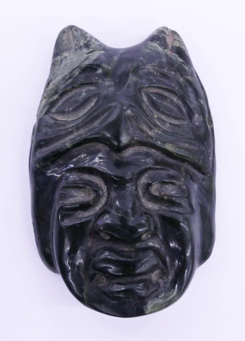 Olmec Jade Jaguar Maskette 2.5''x1.75''. Were jaguar: Olmec Jade Jaguar Maskette 2.5''x1.75''. Were jaguar carved miniature mask. Red museum numbering on verso. Old repair to one ear. Overall excellent condition. Possibly 1200BCE to 400BCE, Mexico. Ex. J