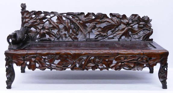 Fine Chinese Rosewood Lotus Bench 30''x64''x24''.: Fine Chinese Rosewood Lotus Bench 30''x64''x24''. Profusely carved figural bench with lotus blossoms and figural duck arm. Similar to a chaise lounge or settee couch. Excellent condition. 19th century