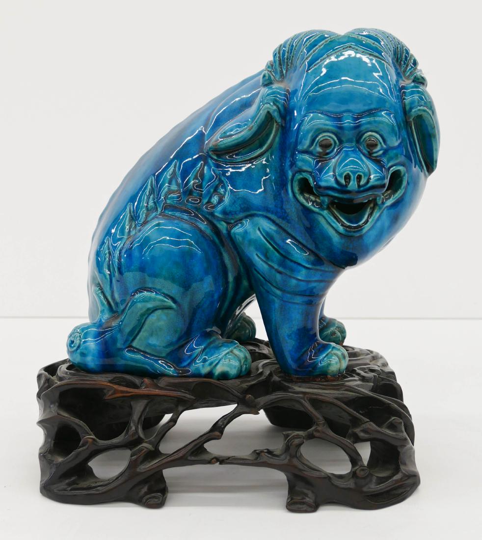 Chinese Peacock Blue Reclining Ox Porcelain Figure on: Chinese Peacock Blue Reclining Ox Porcelain Figure on Stand 13''x11.5''. A large glazed ox or ram figure on fitted carved rosewood naturalistic stand. Excellent condition. Early to mid 20th century, l
