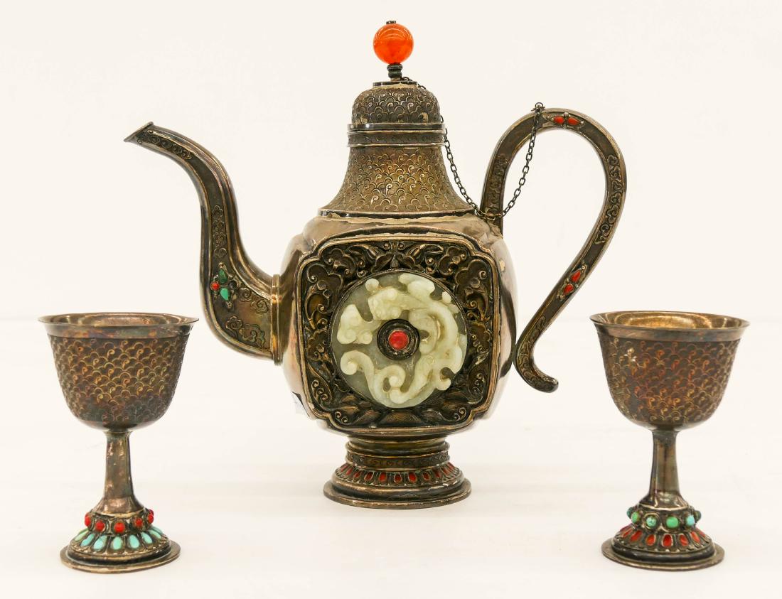 3pc Chinese Mongolian Silver & Jade Teapot with Stem: 3pc Chinese Mongolian Silver & Jade Teapot with Stem Cups. Includes a hand chased teapot 8''x8'' with two inset carved jade qilin bi discs 2'' each. Comes with a matching pair of wine cups with inset 