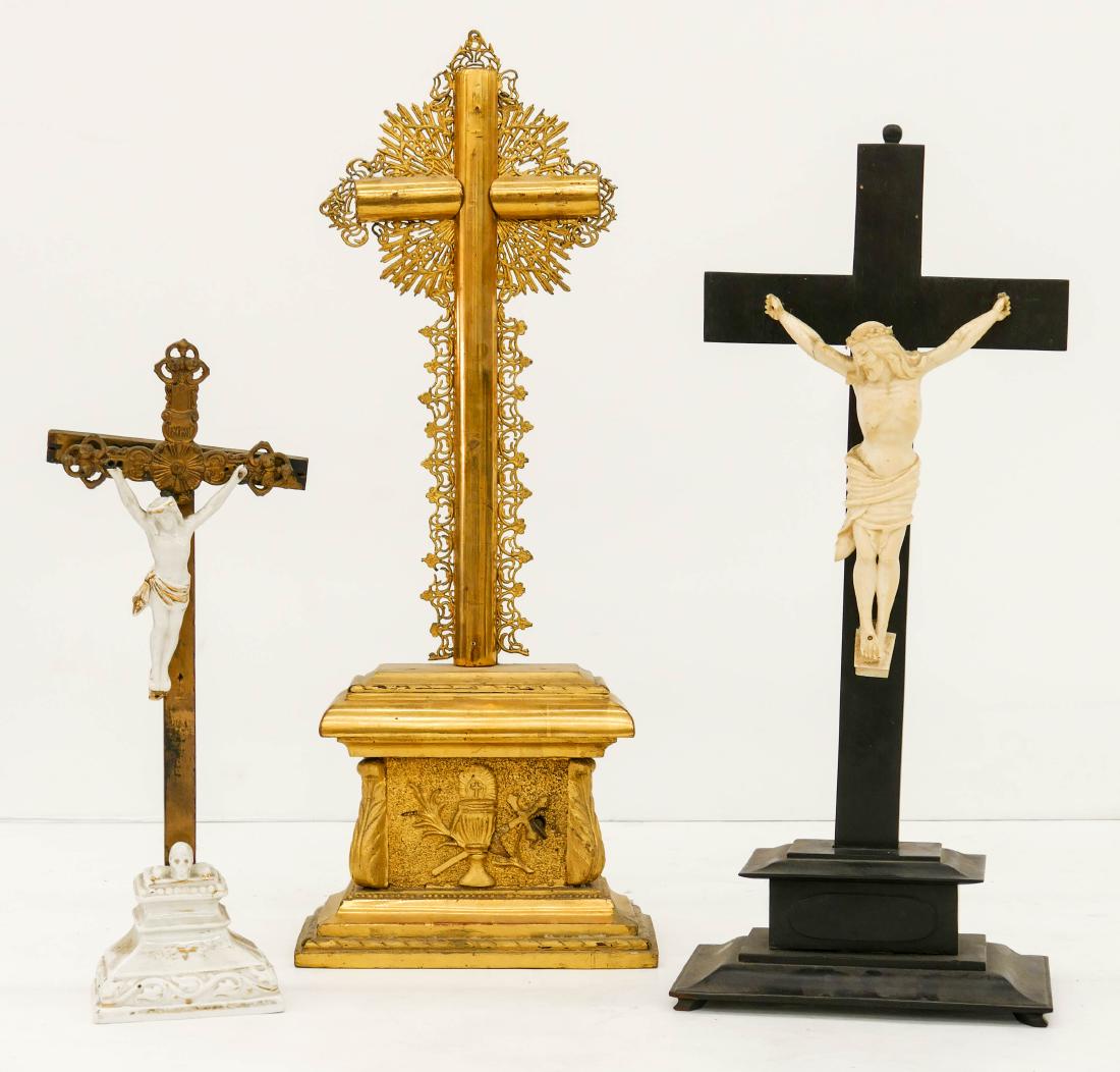 3pc Antique Church Altar Crucifixes. Includes a gilt: 3pc Antique Church Altar Crucifixes. Includes a gilt wood music box crucifix 23''x8.5'', a carved ebony crucifix 19''x8'', and a porcelain and wood crucifix (jesus is missing hand) 14.5''x5.5''. Some