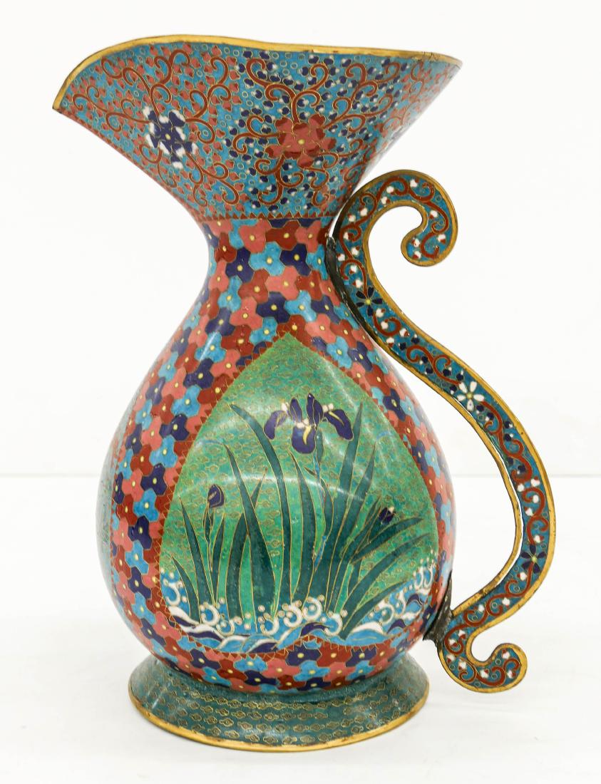 Unusual Meiji Japanese Cloisonne Large Pitcher: Unusual Meiji Japanese Cloisonne Large Pitcher 12''x8.5''. A polychrome enameled brass handled vessel with iris and chrysanthemum flowers. Some minor edge flaking, overall excellent condition. 19th ce
