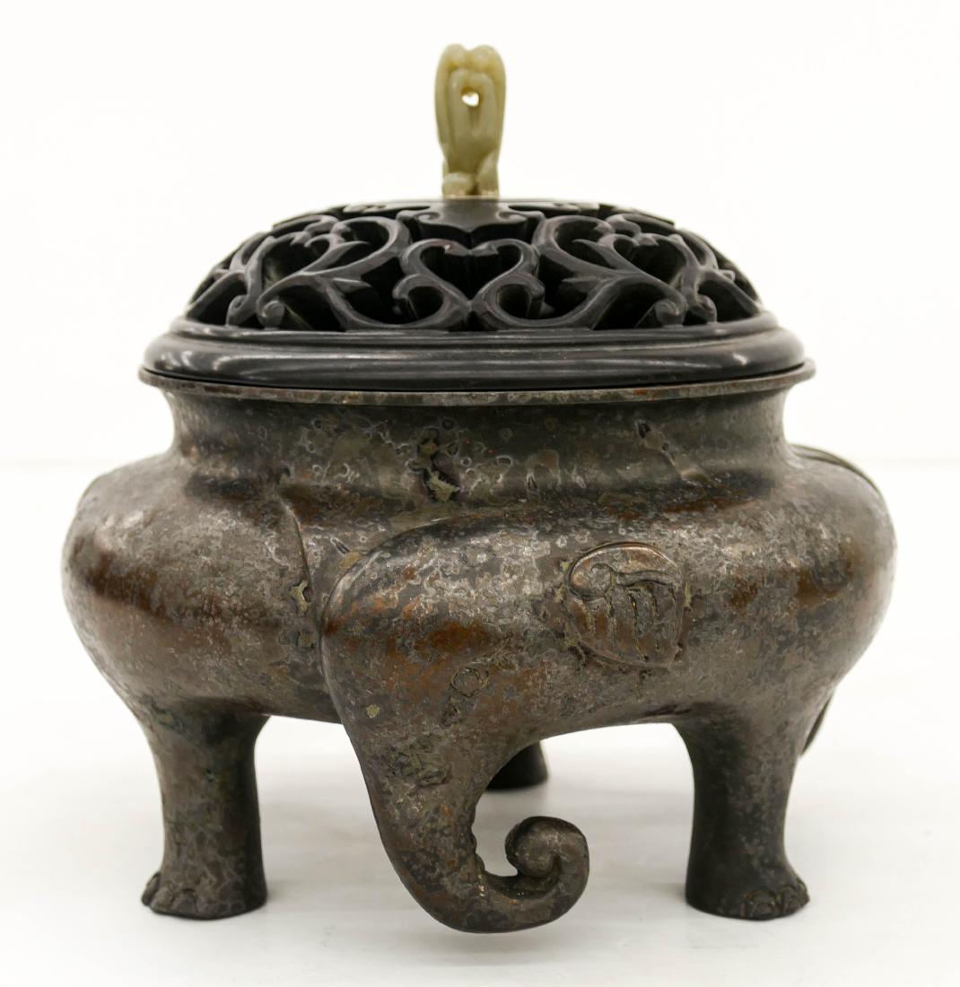 Chinese Bronze Elephant Covered Censer 7.5''x8''. A: Chinese Bronze Elephant Covered Censer 7.5''x8''. A tripod figural three elephant censer with pierced carved rosewood lid and jade finial. Large Ming seal on bottom. Scattered surface wear and corrosi