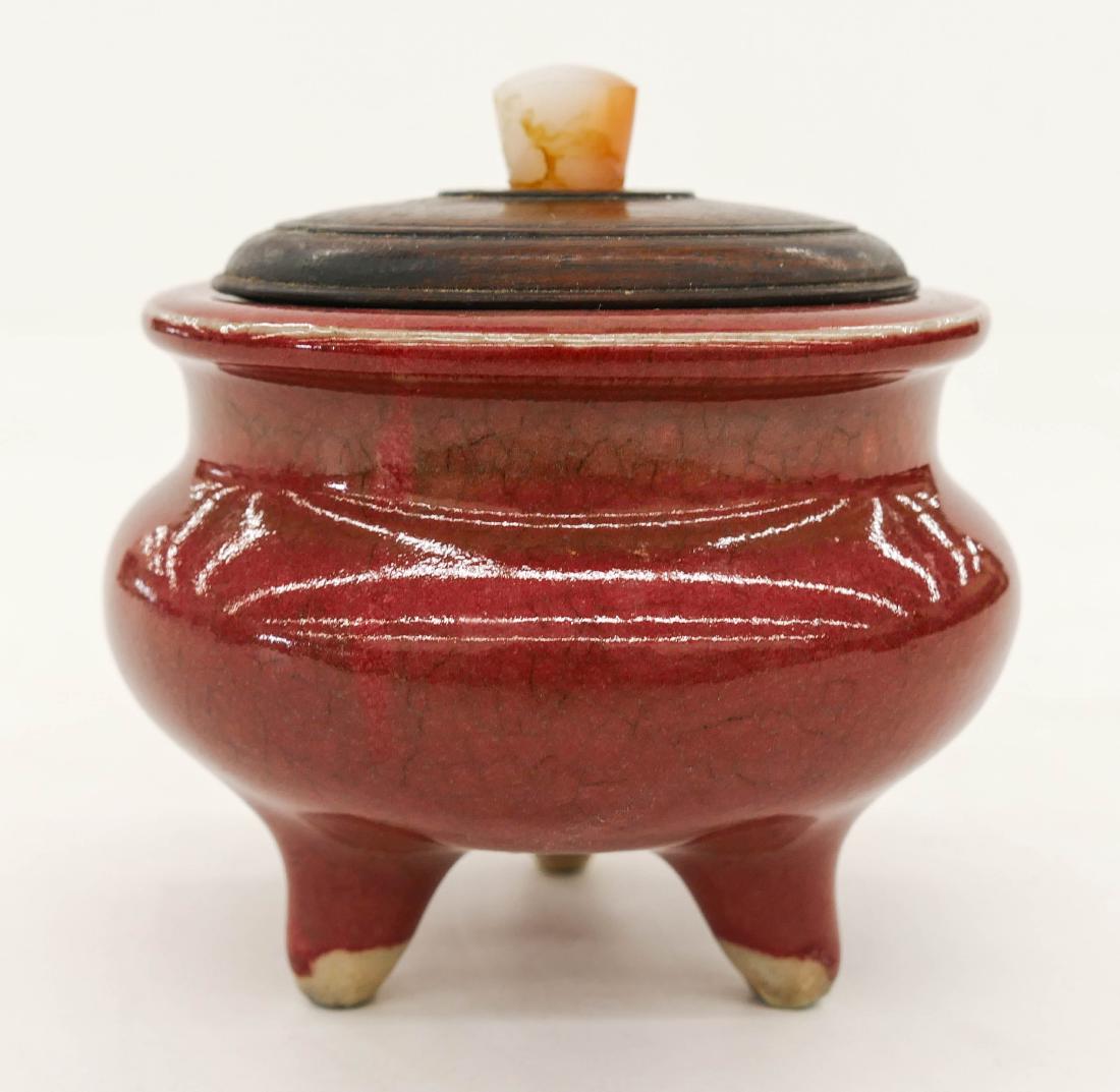 Fine Chinese Sang de Boeuf Porcelain Censer 3.5''x4''.: Fine Chinese Sang de Boeuf Porcelain Censer 3.5''x4''. An oxblood glazed porcelain tripod censer with carved rosewood lid and carnelian agate finial. Excellent condition. 19th century, Qing dynasty.