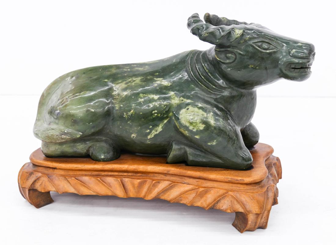 Large Chinese Jade Reclining Ox Figure on Stand: Large Chinese Jade Reclining Ox Figure on Stand 9''x13''. A large green jade boulder carving of a reclining ox with a carved fitted rosewood stand. Excellent condition. 20th century, Republic era.