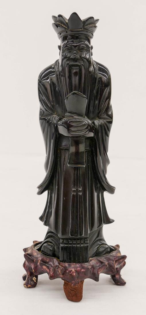 Chinese Amber Court Attendant Figure on Stand: Chinese Amber Court Attendant Figure on Stand 9''x3.5''. A solid carved cherry amber figure of a court figure holding a hu tablet. Carved rosewood fitted stand affixed to figure. It weighs 394 grams.