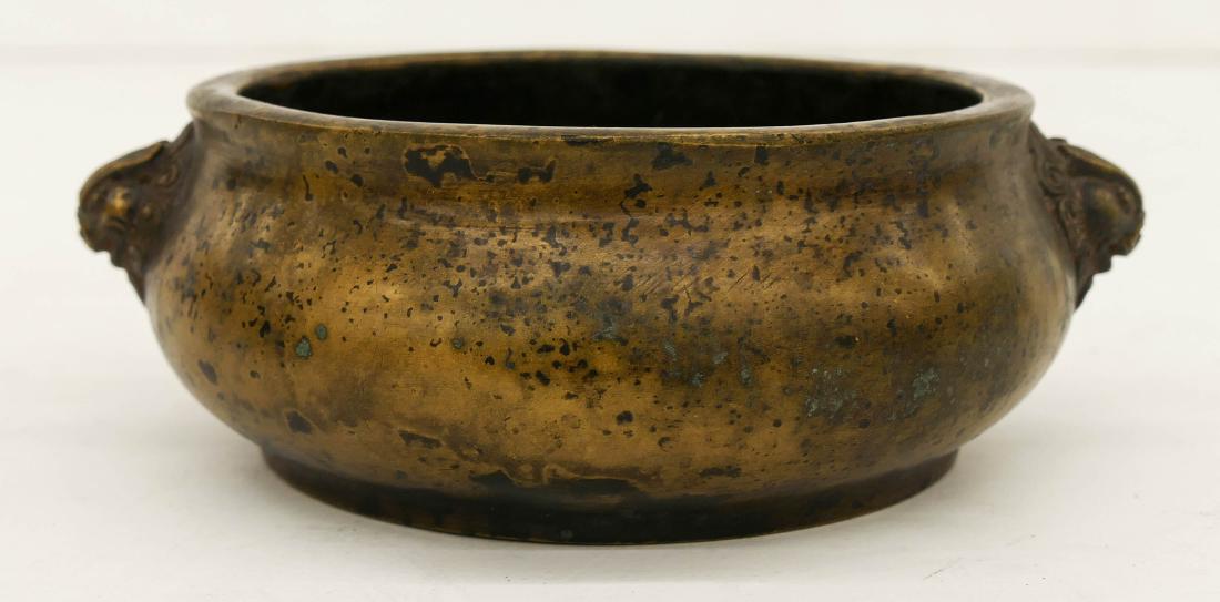 Chinese Bronze Small Censer 2''x6''. Figural qilin head: Chinese Bronze Small Censer 2''x6''. Figural qilin head handles. Xuande Ming seal mark on bottom. Scattered surface wear. It weighs 805 grams.