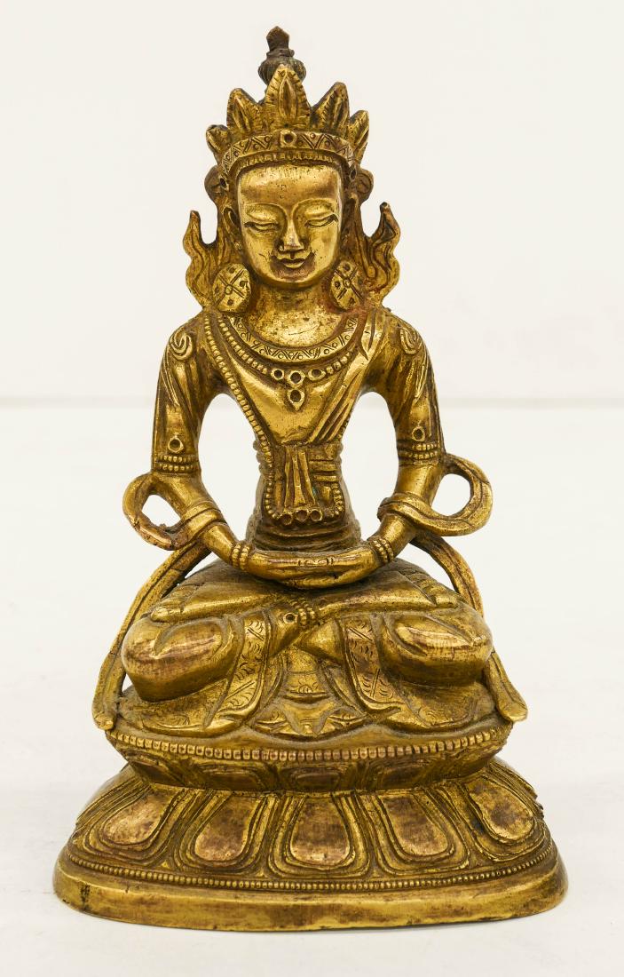 Tibetan Gilt Bronze Seated Buddha 6.5''x4''. A hand: Tibetan Gilt Bronze Seated Buddha 6.5''x4''. A hand chased gilt bodhisattva seated on throne. Some scattered light surface wear from age. Overall excellent condition. 19th or 20th century, possibly Si