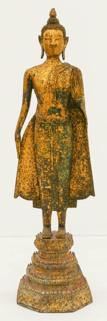 Thai Gilt Bronze Standing Buddha 24''x7''. A parcel: Thai Gilt Bronze Standing Buddha 24''x7''. A parcel gilt and red lacquered Rattakosin style standing buddha on throne. Scattered surface wear from age. Overall excellent condition. 19th century, simil