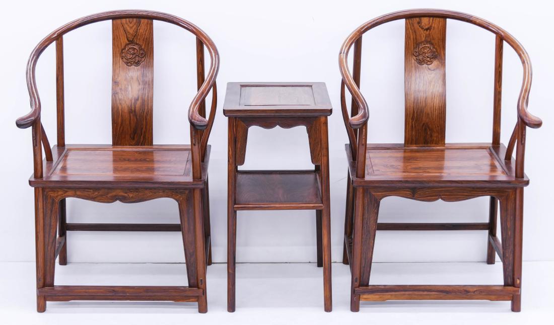 3pc Chinese Huanghuali Horseshoe Chair & Table Set.: 3pc Chinese Huanghuali Horseshoe Chair & Table Set. Includes a pair of relief carved Ming style horseshoe chairs 40''x24''x23'' each and a matching tea table 29.5''x17''x14.5''. Excellent condition. 2