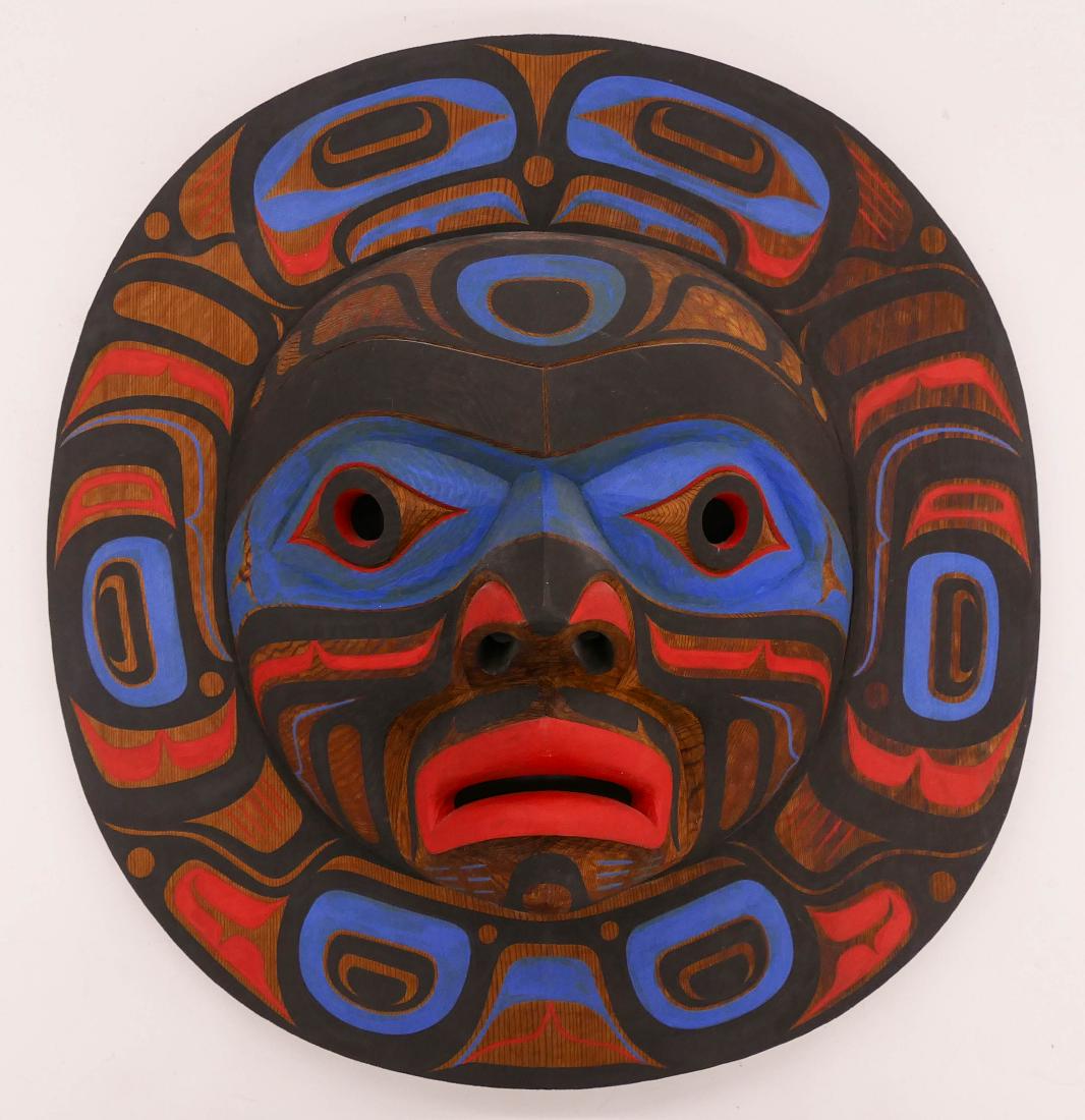 Tony Hunt Jr. (1961-2017 Kwakiutl) Moon Mask 1984 Cedar: Tony Hunt Jr. (1961-2017 Kwakiutl) Moon Mask 1984 Cedar 16''x16''x5''. A carved and painted native mask. Signed and dated on verso. Overall excellent condition.