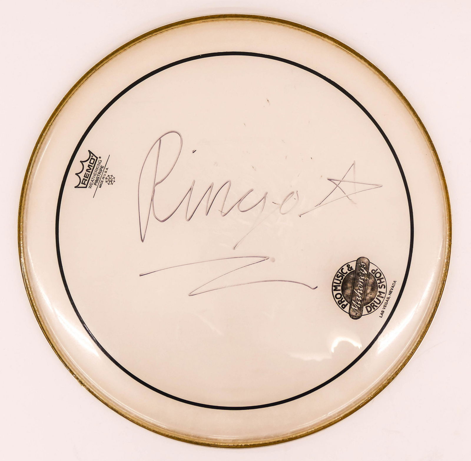 Ringo Starr Autographed Remo Drum Head 16.5''. Acquired: Ringo Starr Autographed Remo Drum Head 16.5''. Acquired from the collection of Scott Francis Crago, former drummer for The Eagles. Signed in black ink with star. Drum head shows some use. Estate piece