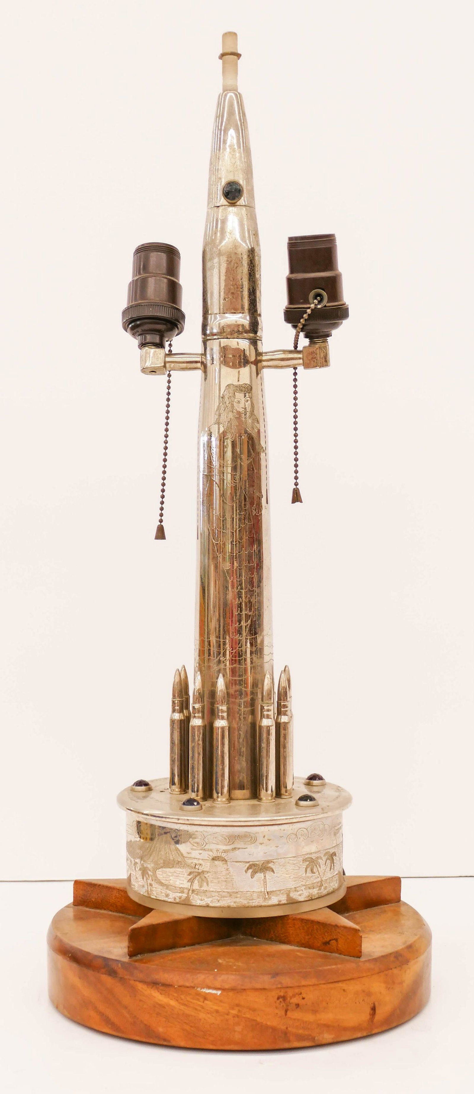 WWII US Trench Art Jeweled Mermaid Lamp 25''x10''.: WWII US Trench Art Jeweled Mermaid Lamp 25''x10''. Unusual nickel plated brass lamp with central mermaid and south pacific scene. Artillery shell jeweled form with a list of several sunken ships from 