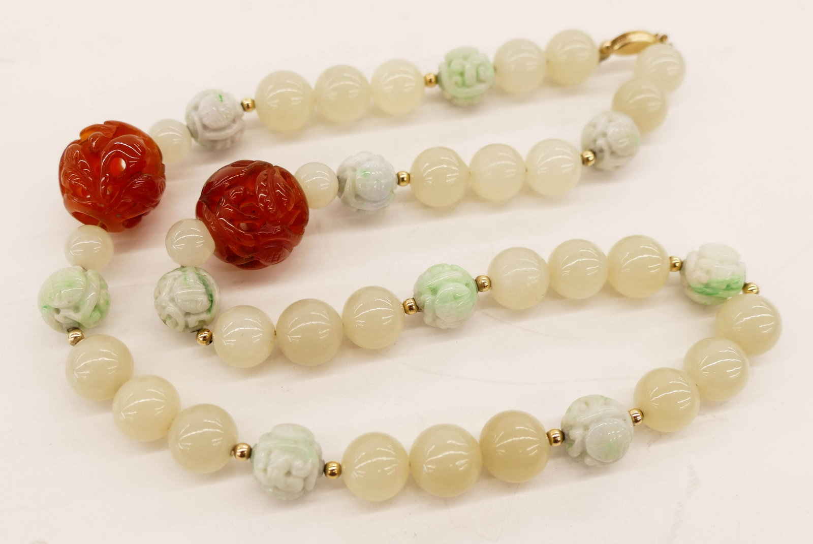 Chinese Jade and Carnelian Bead Necklace 20''. Includes: Chinese Jade and Carnelian Bead Necklace 20''. Includes (2) pierced carved carnelian 19mm beads with (10) carved shou jade beads 11mm, and (29) celadon white jade beads 8-11mm. No damage.