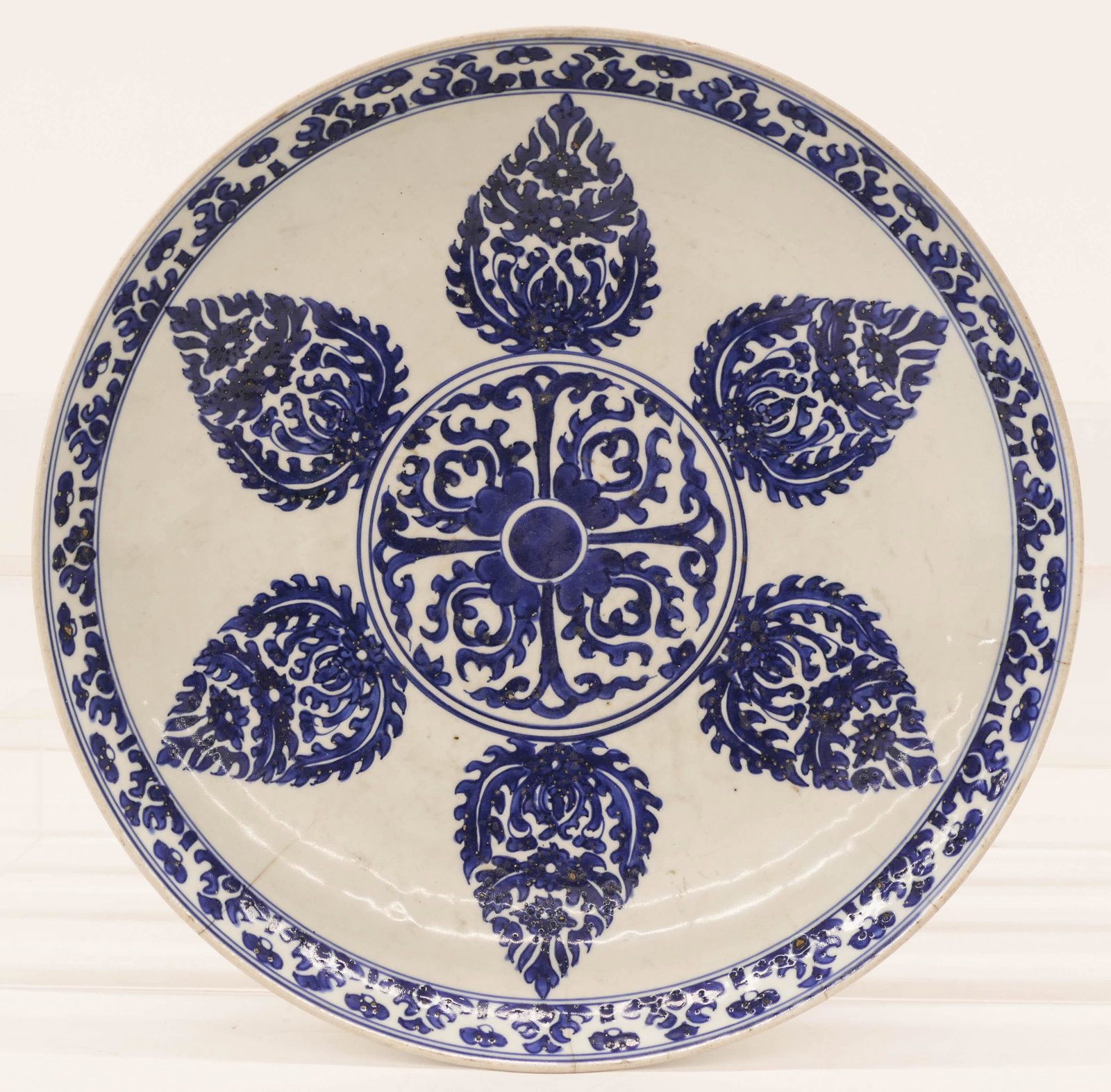 Chinese Kangxi Islamic Market Porcelain Deep Charger: Chinese Kangxi Islamic Market Porcelain Deep Charger 14''. A blue and white underglaze charger with medallion and petals. Four tight hairline edge cracks with a few small edge chips. 18th century, Qin