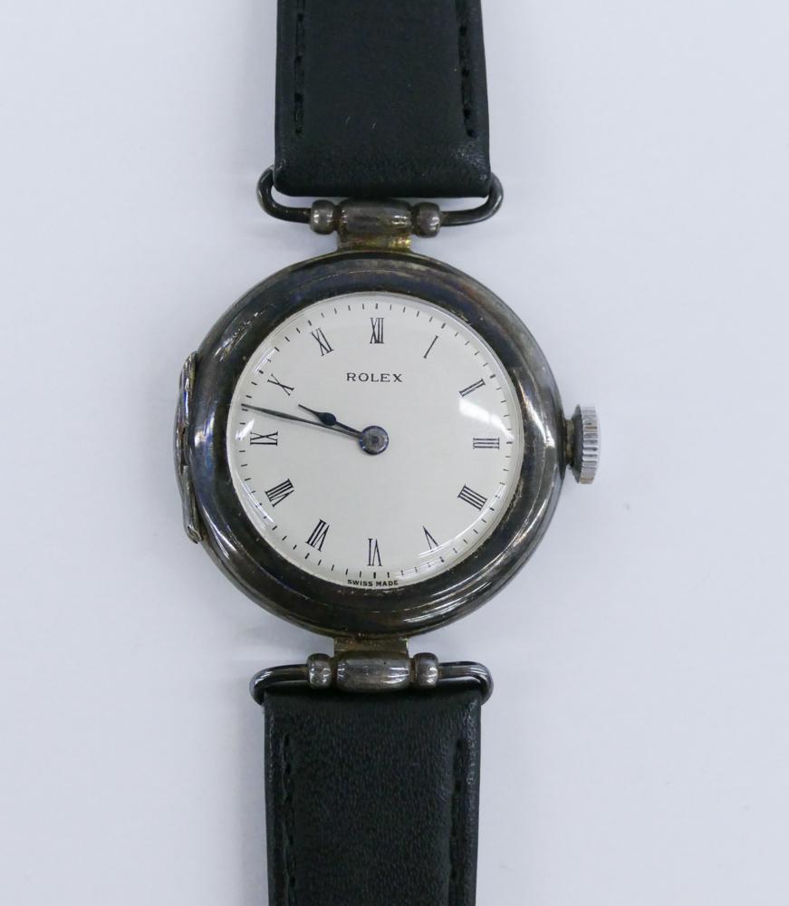 Rolex Trench Style Sterling Silver Wristwatch: Rolex Trench Style Wristwatch. Sterling Silver 30mm Case. English date hallmark of 1912 on inside case back. Case stamped 506594. Movement is in working order. Unused Genuine Calfskin Black Leather Ba