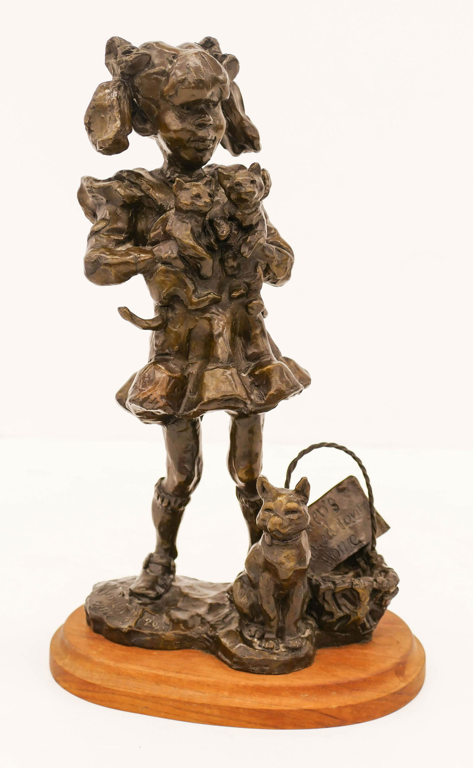 Gary Schildt (b.1938 Oregon) ''Kittens Need Loving: Gary Schildt (b.1938 Oregon) ''Kittens Need Loving Home'' 1984 Bronze Sculpture 12.5''x7.5''. A whimsical bronze of a little girl with kittens. Signed and numbered 20 of 38. Missing one screw on botto