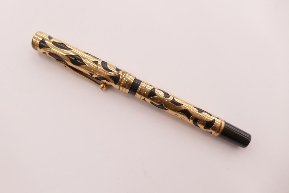 Waterman's Ideal Gold Fill Overlay over Black Bakelite: Waterman's Ideal Gold Fill Overlay over Black Bakelite Fountain Pen. Nib: Waterman`s Ideal New York `2`. Engraved 'TC' in script. 5.25'' long overall, 4.75'' length pen only.