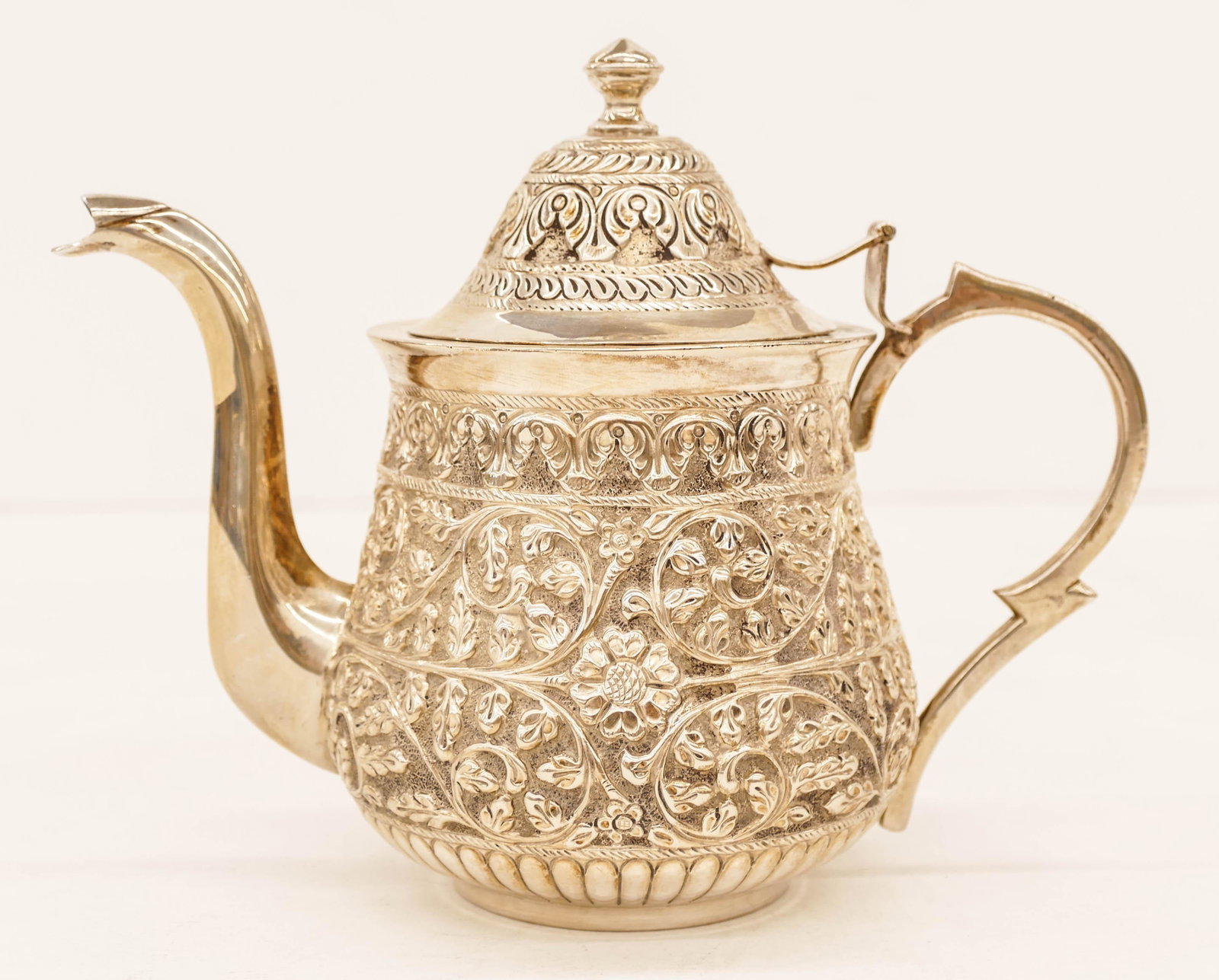Persian 800 Silver Repousse Teapot 6''x7.5''. Heavy: Persian 800 Silver Repousse Teapot 6''x7.5''. Heavy repousse scrolling flower motifs. Marked SILVER 800 in oval. It weighs 16.2 troy ounces. Excellent condition with no monograms.
