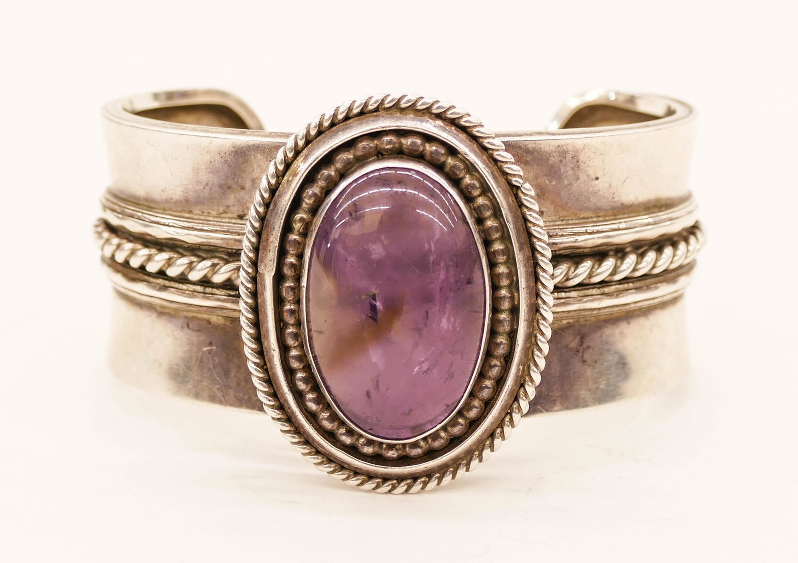 Ben Chavez Navajo Sterling Quartz Cuff Bracelet: Ben Chavez Navajo Sterling Quartz Cuff Bracelet 1.75''x2.75''. Hand made bracelet with central purple quartz cabochon. Signed on interior. It weighs 94 grams. Excellent condition.