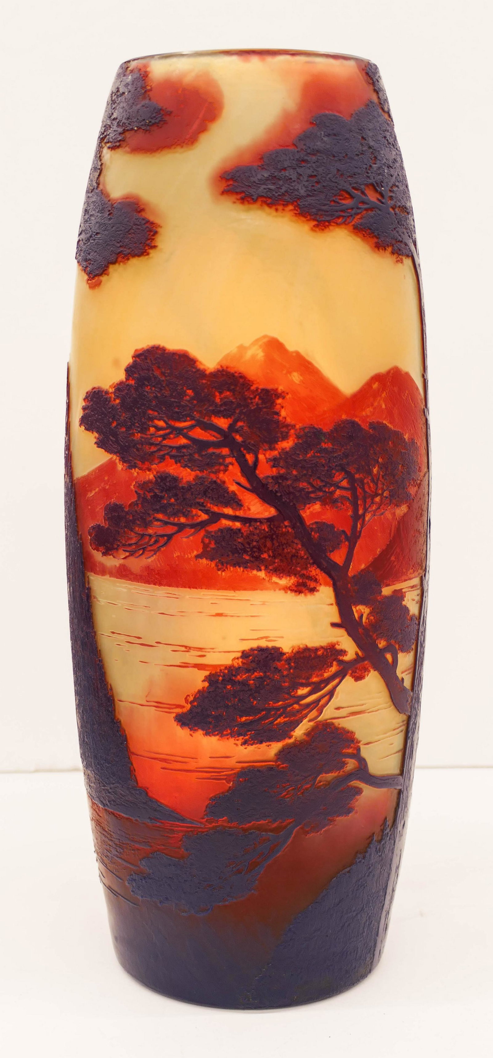 Large DeVez Cameo Glass Landscape Vase 13.5''x5.5''. A: Large DeVez Cameo Glass Landscape Vase 13.5''x5.5''. A blue to amber acid cut mountain scene vase with castle on hill. Signature on side. Excellent condition. Similar to Galle or Daum pieces.