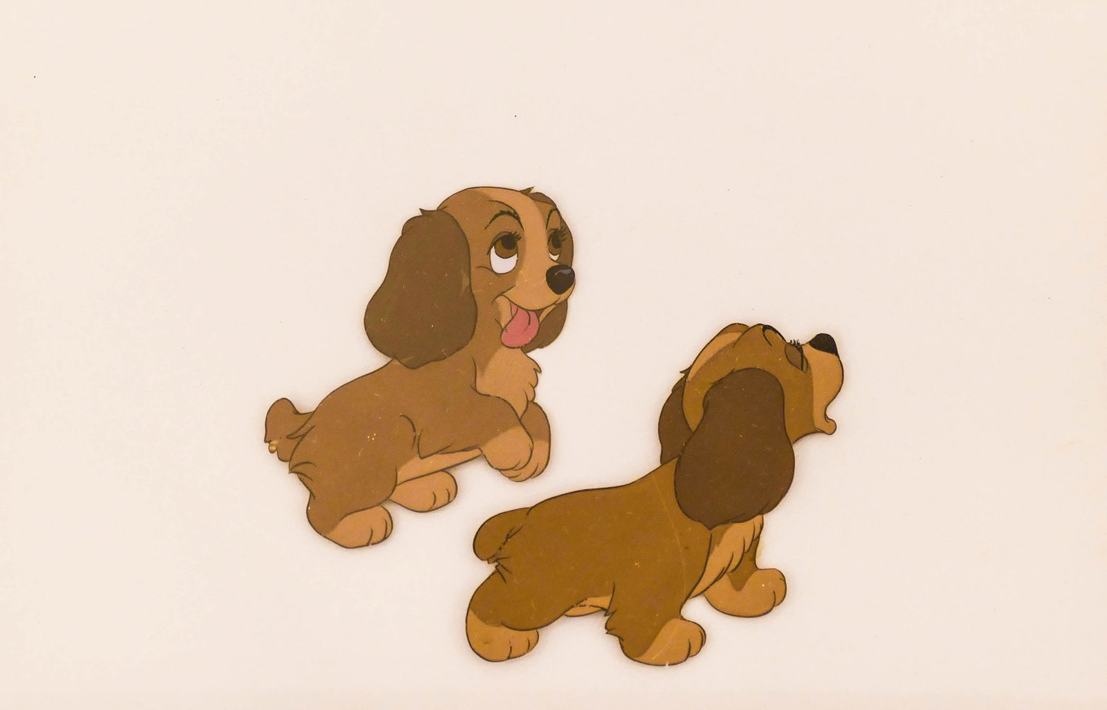 1955 Disney ''Lady and the Tramp'' Puppies Animation: 1955 Disney ''Lady and the Tramp'' Puppies Animation Cel 7''x10.5'' Sight. An original painted celluloid production cel. Plasteel professional framing 12.5''x16''. Some scattered slight surface marks 