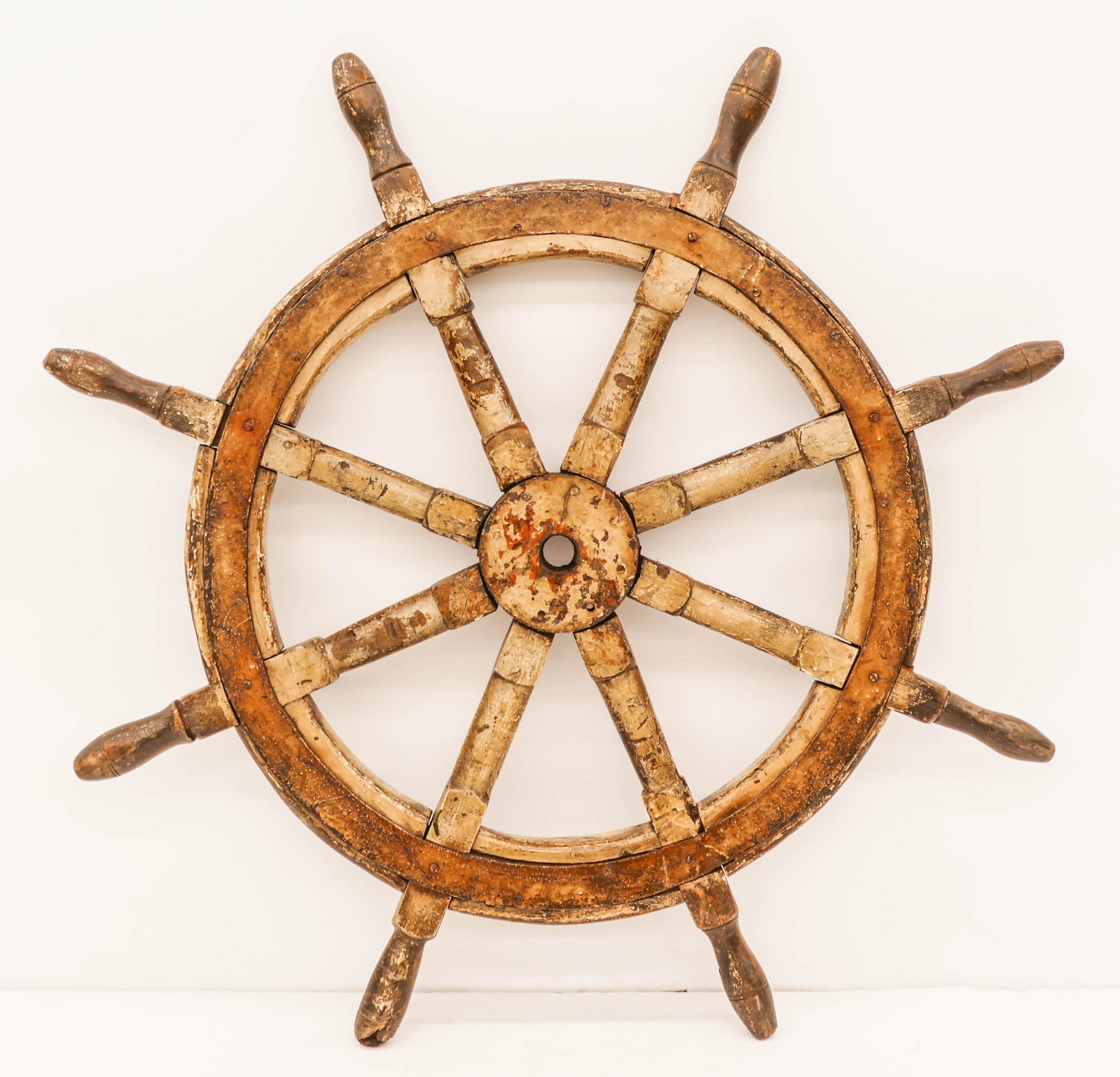 Antique Ship's Wheel with Old White Paint 38''. Steel: Antique Ship's Wheel with Old White Paint 38''. Steel and oak ships wheel with remnants of its original white paint. Great patina and decorator piece. Overall surface wear from age. (GW)