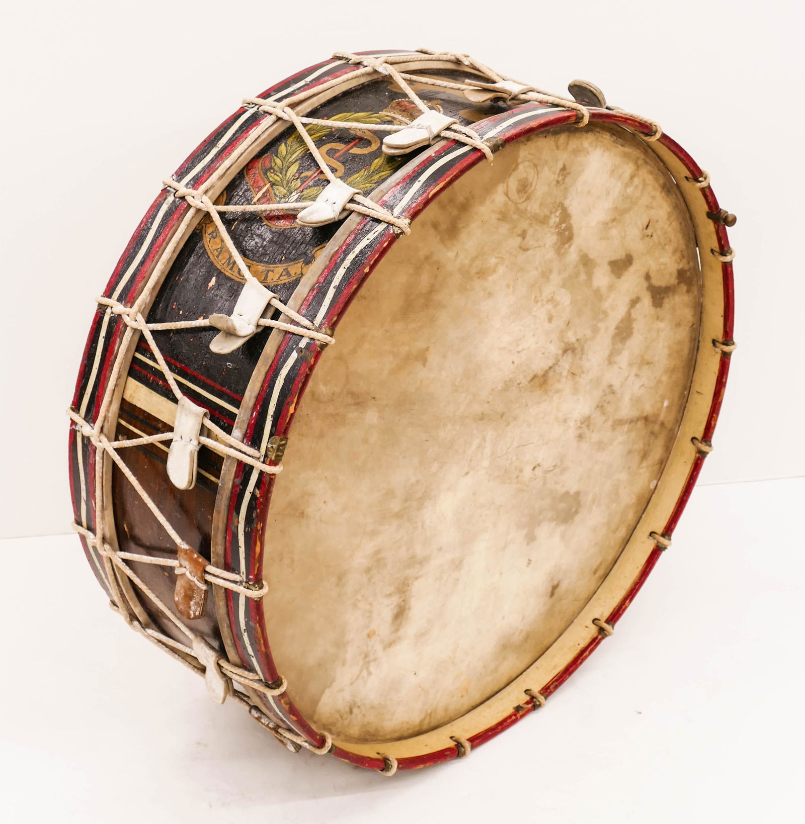 WWI Royal Army Medical Corps Large Painted Marching: WWI Royal Army Medical Corps Large Painted Marching Drum 33''x13''. Polychrome painted wood drum with their crest painted on side. Scattered surface wear from use.