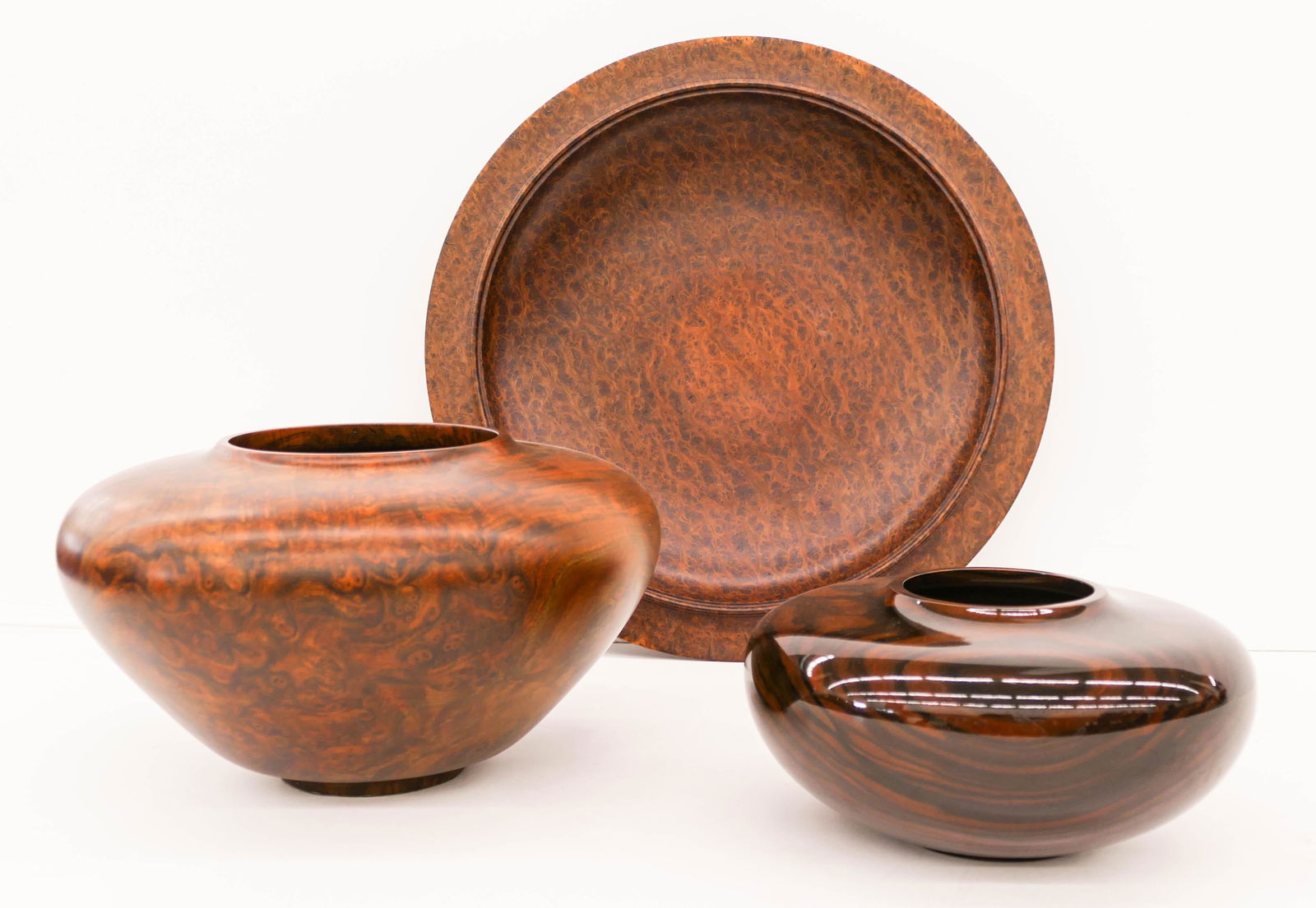 3pc Jon Kruger Turned Wood Vessels and Charger.: 3pc Jon Kruger Turned Wood Vessels and Charger. Includes a Walnut Burl larger vase 7''x12'', an Ebony squat vase 5''x9'', and a Redwood Burl shallow charger 17''x2''. Each is signed and notated on bot