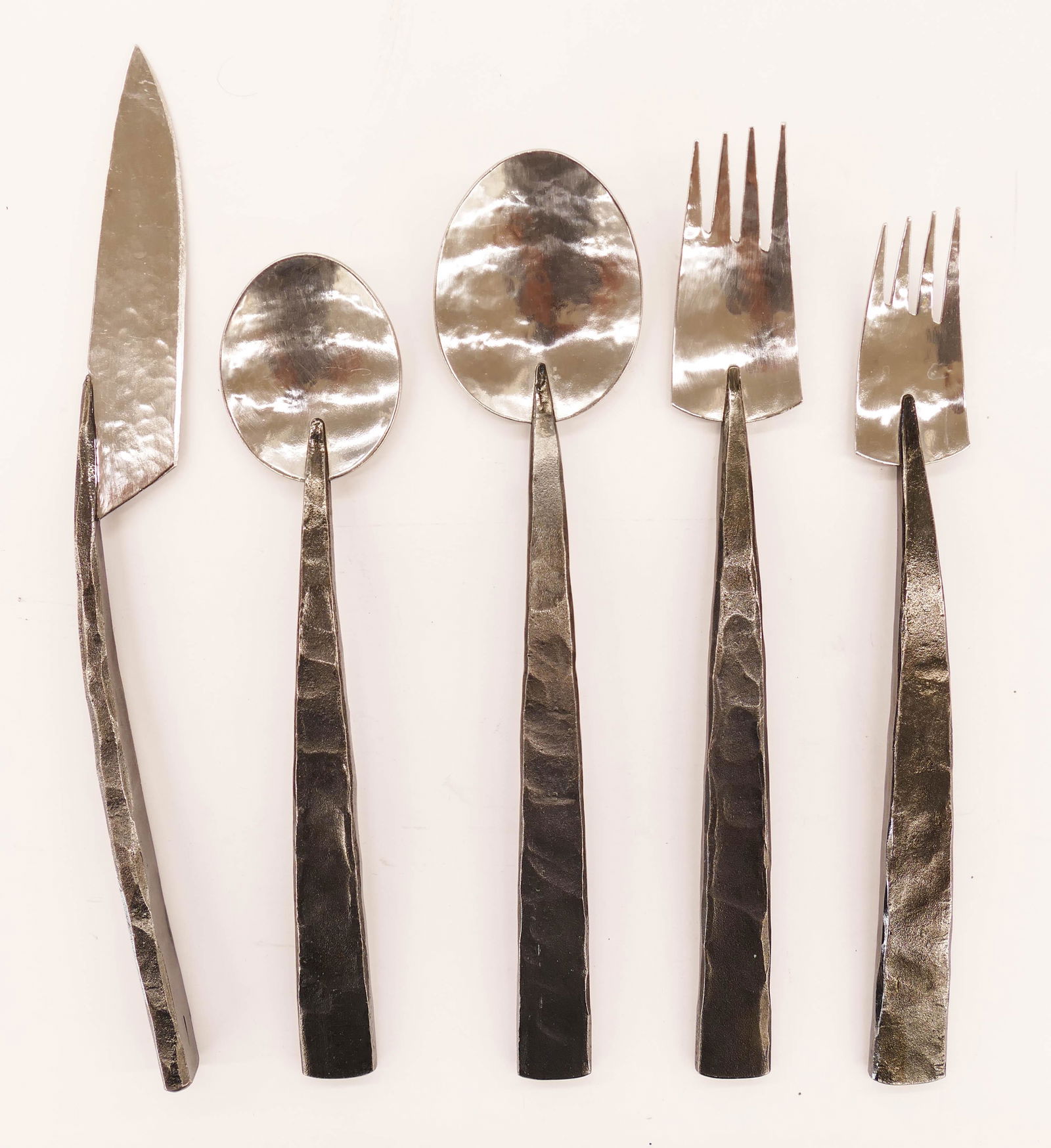 Norman Lloyd (20/21st Cent. American) Hand Forged Steel: Norman Lloyd (20/21st Cent. American) Hand Forged Steel Art Flatware Service 8'' to 10''. Includes (56) pieces to form a complete service for ten plus extras. Unmarked. A commissioned custom set. Coll