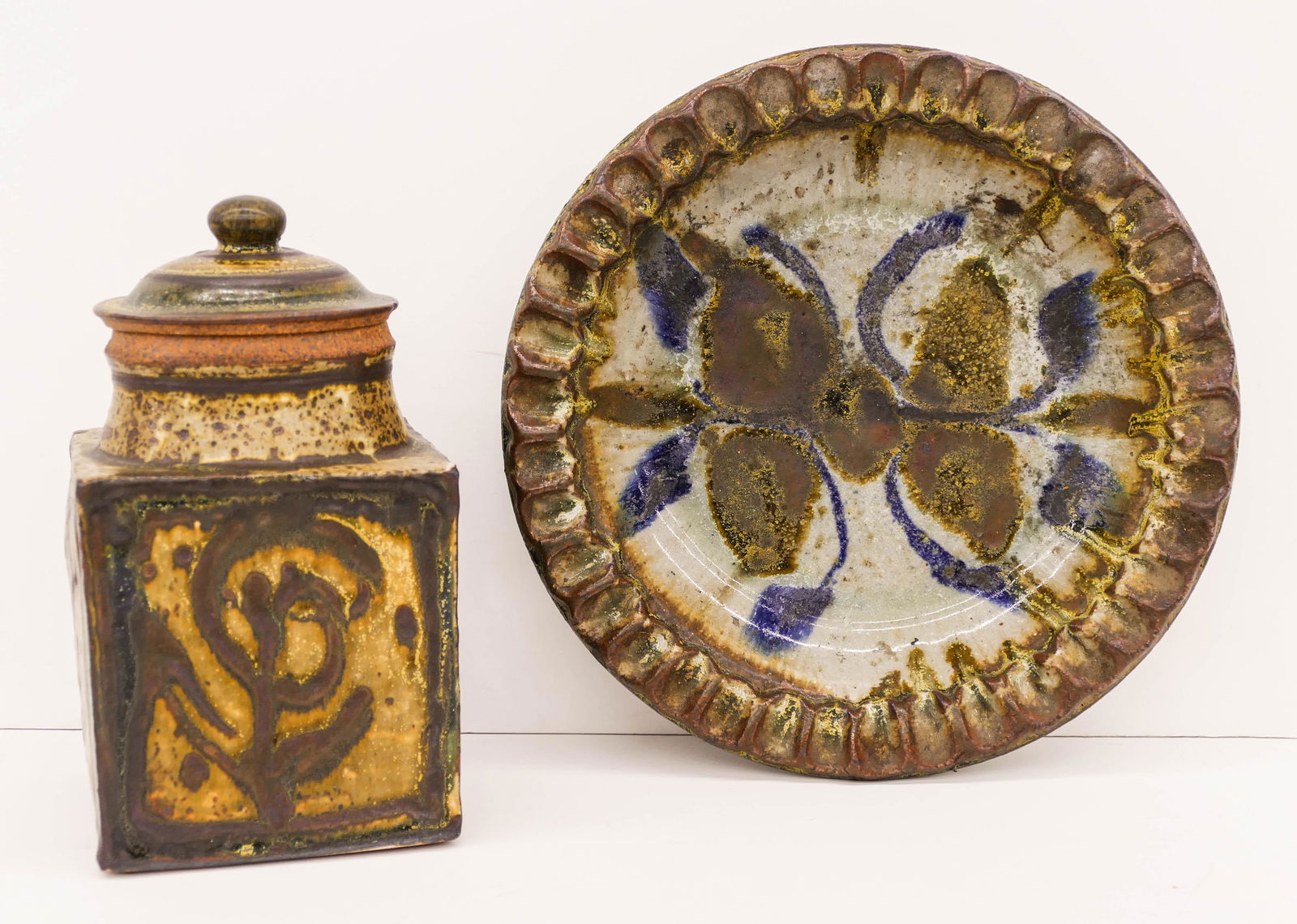 2pc Robert Sperry & William Creitz Studio Pottery.: 2pc Robert Sperry & William Creitz Studio Pottery. Includes a Creitz covered square jar 8'' and a Sperry crimped edge bowl 10''. Sperry is stamped and jar is unmarked. Slight edge flake to lid. Overal