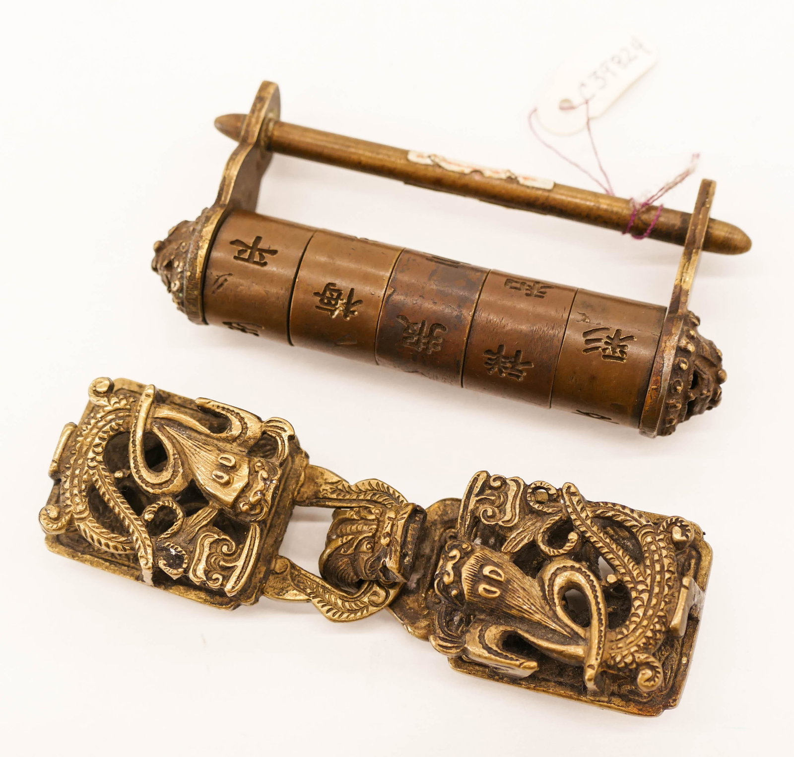 2pc Old Chinese Brass Buckle and Lock. Includes a: 2pc Old Chinese Brass Buckle and Lock. Includes a pierced dragon buckle 3.5'' and a combination lock 3.25''. Some light wear from age. 19th century, Qing dynasty.