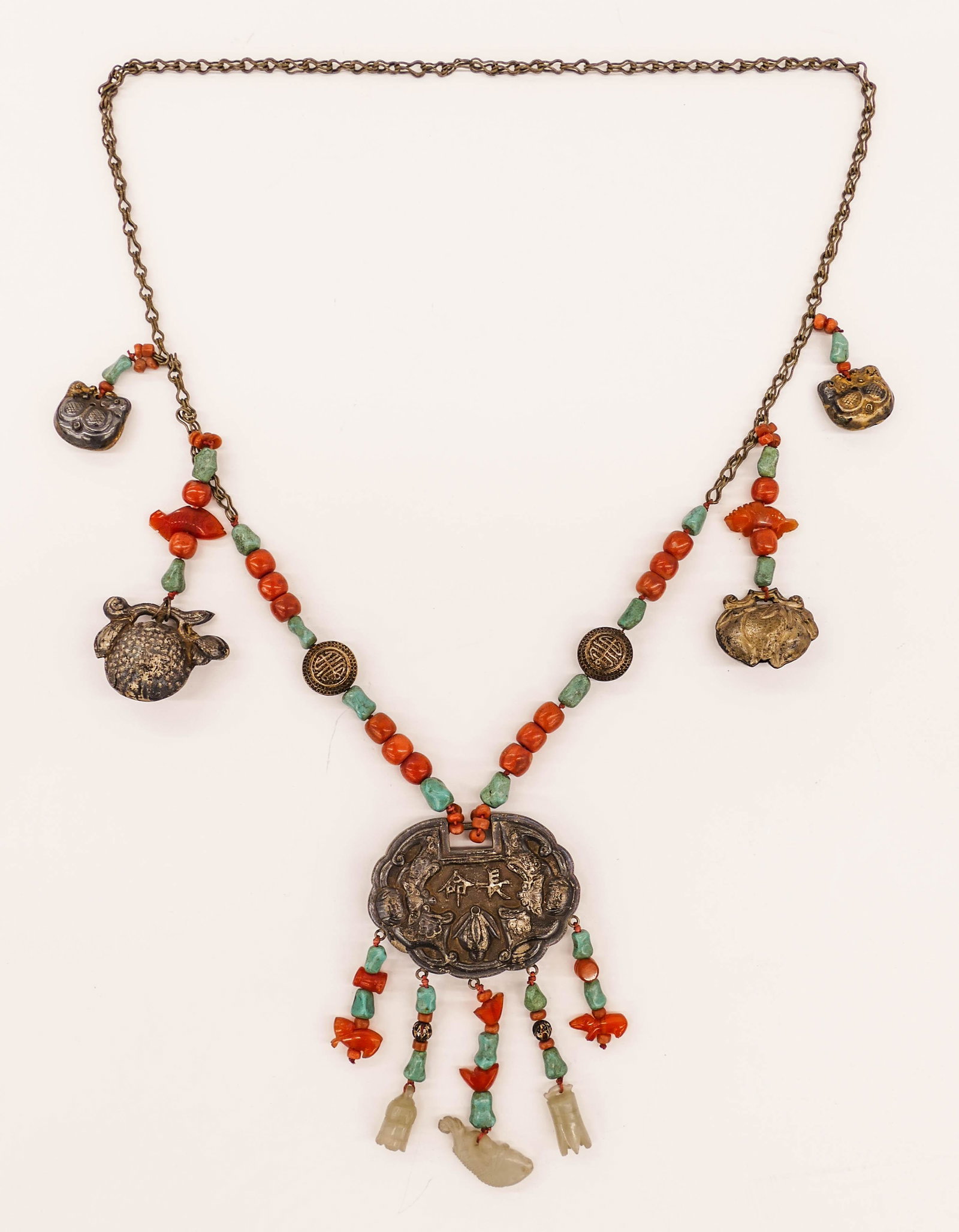 Old Chinese Silver Lock Jade & Coral Toggle Necklace: Old Chinese Silver Lock Jade & Coral Toggle Necklace 29''. Impressive necklace with twin bat lock and figural toggles. Natural coral, turquoise, and carnelian beads with figural jade toggles. Pendant 